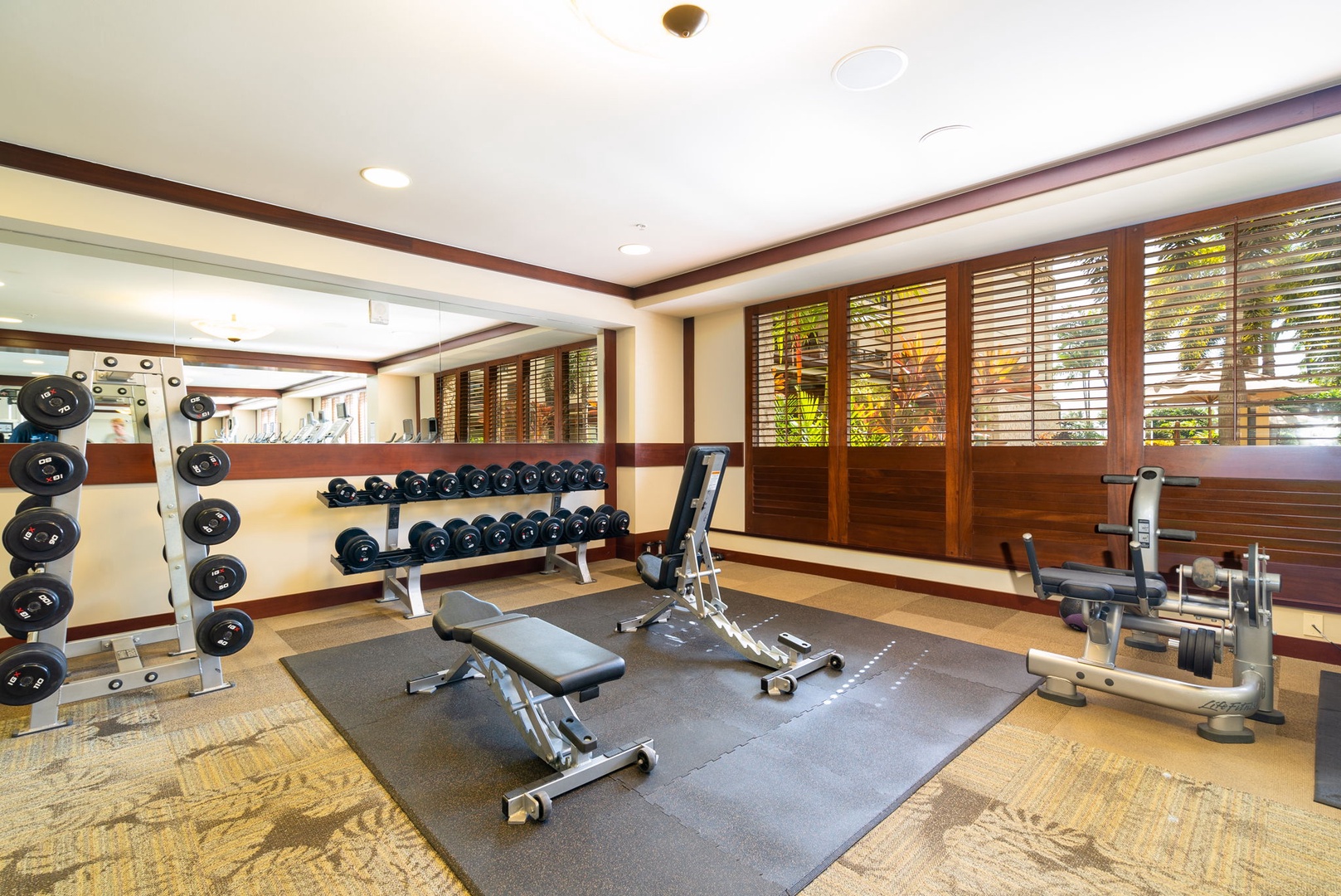 Kapolei Vacation Rentals, Ko Olina Beach Villas B604 - Stay fit during your getaway in this well-equipped fitness center, featuring free weights and machines with natural light streaming through wooden shutters.