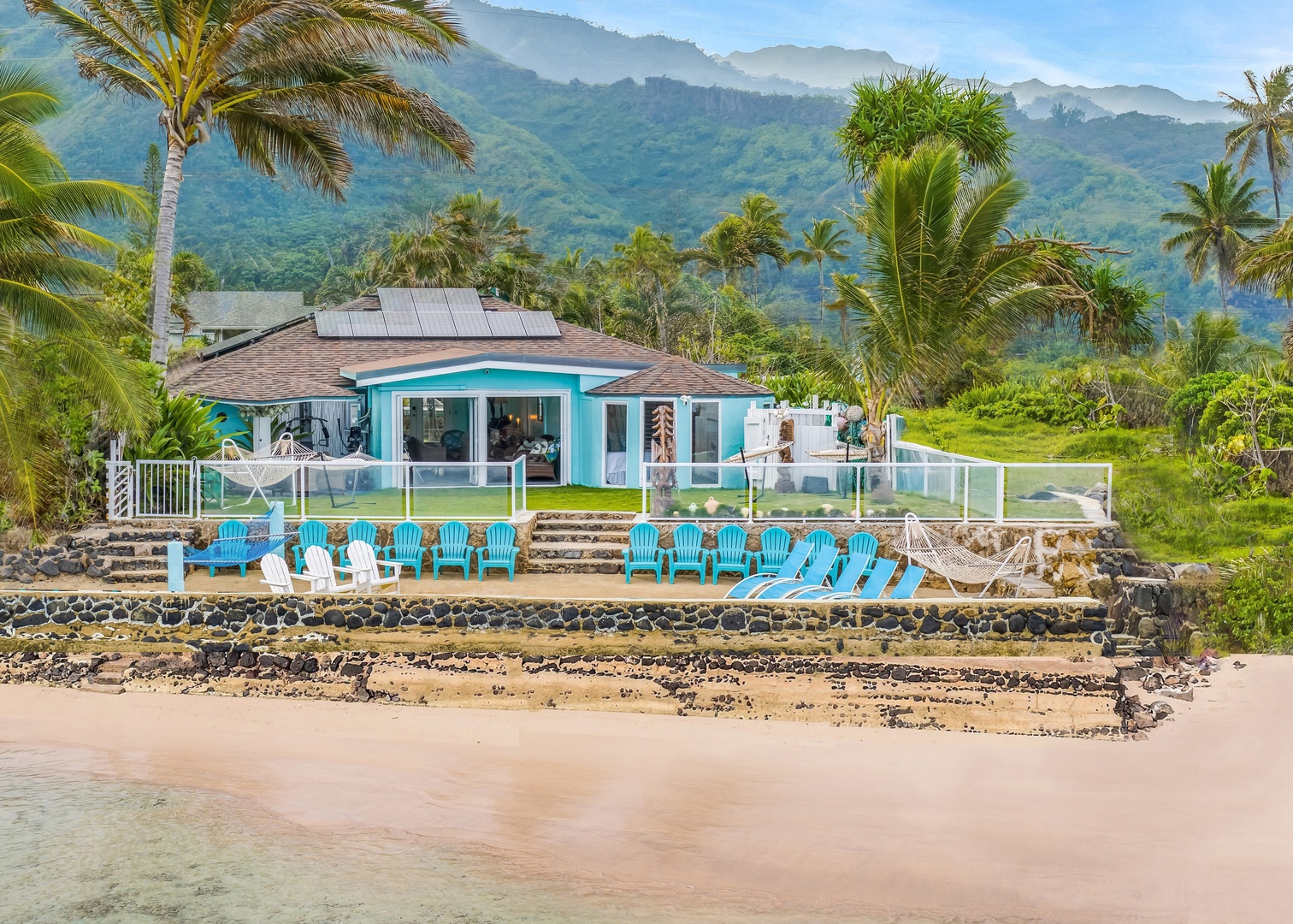 Hauula Vacation Rentals, Private Beach Paradise - Beachfront from the first step outside, loungers lined along the wall above the sand.