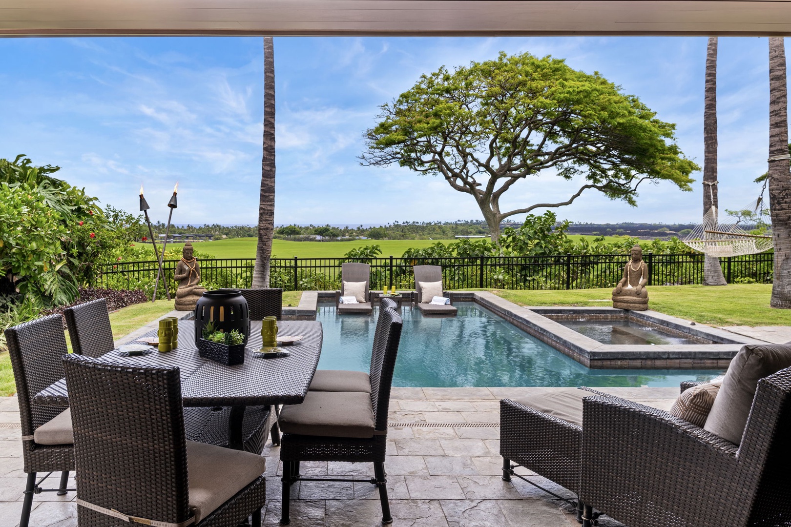 Kailua Kona Vacation Rentals, 3BD Pakui Street Estate (149) at Hualalai Resort - Dinner on the covered lanai, the pool and fairway spread out just beyond.