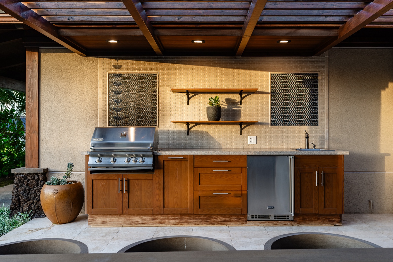 Kamuela Vacation Rentals, Beach Walker at Champion Ridge - Outdoor kitchen equipped with a built-in grill, refrigerator, and ample counter space, perfect for cooking and entertaining in the open air.