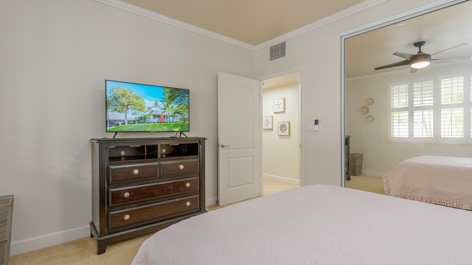 Kapolei Vacation Rentals, Ko Olina Kai 1027A - The second guest bedroom with a dresser and TV.