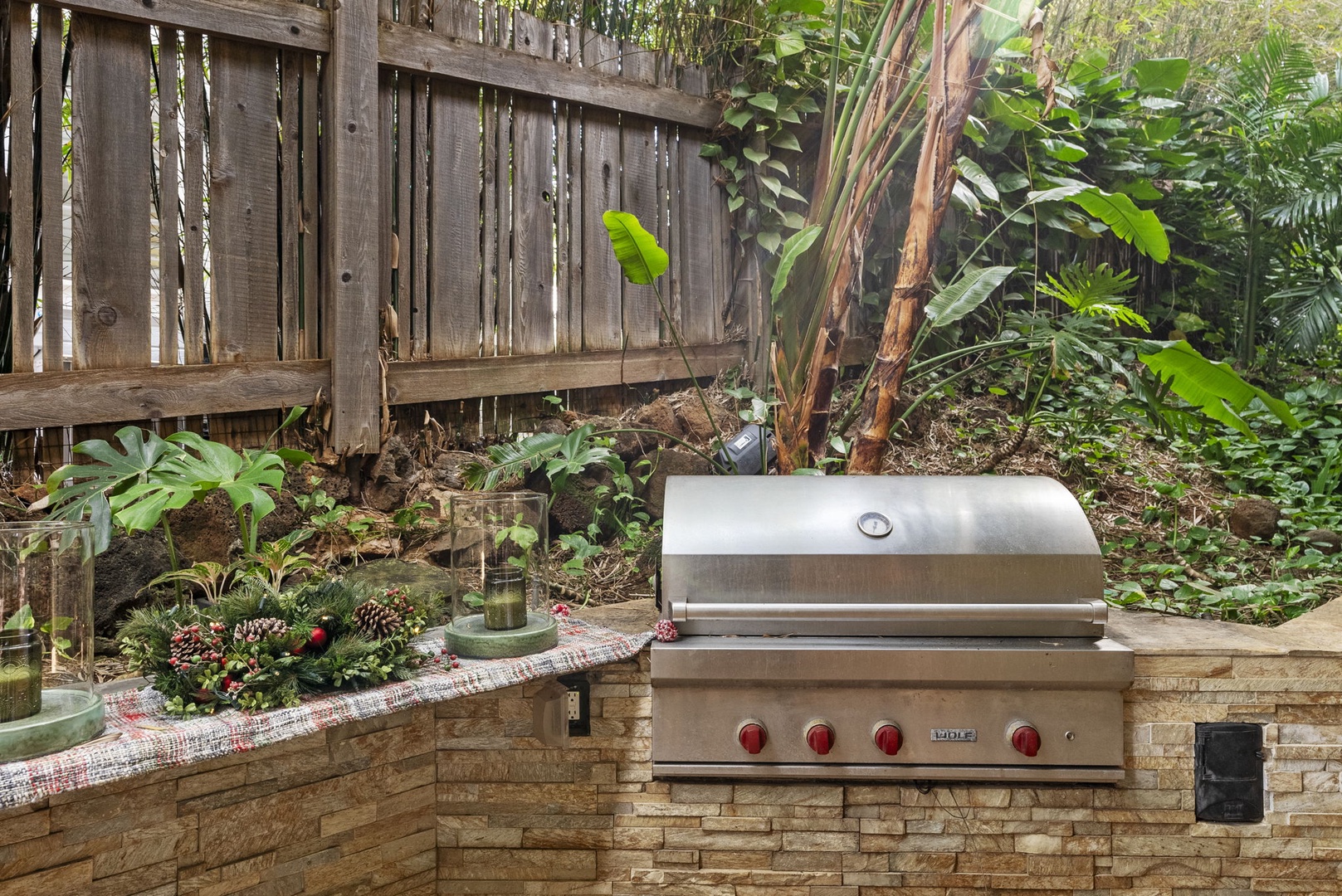 Honolulu Vacation Rentals, Pili Pono - Outdoor barbecue grill area surrounded by lush greenery.