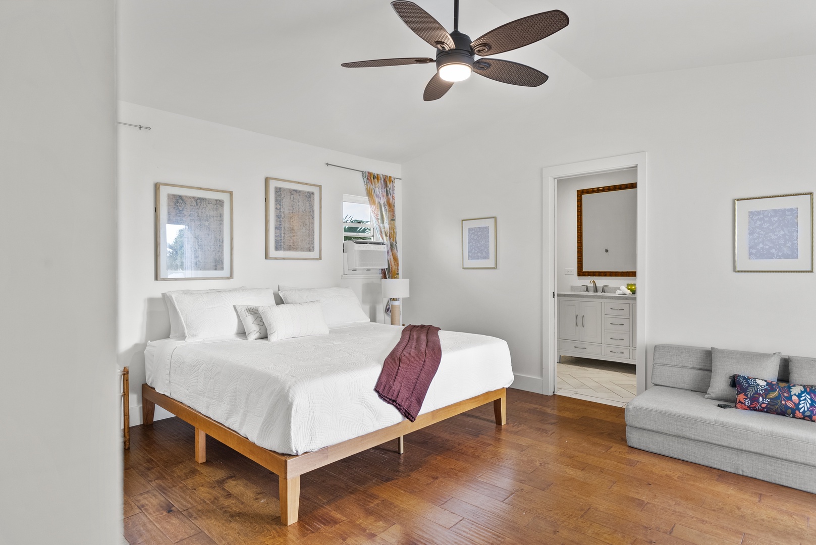 Kaaawa Vacation Rentals, Ka'a'awa Hale - Bright bedroom with cozy hardwood floors and a private ensuite bathroom.