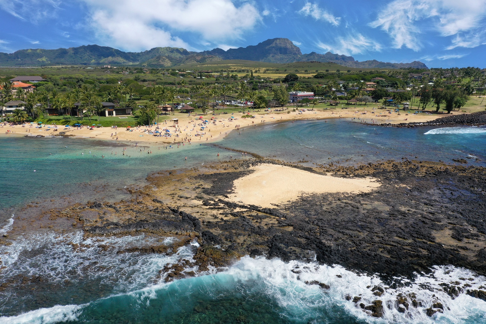 Koloa Vacation Rentals, Ke Kai Nui at Kukuiula - Take in the stunning aerial view of Poipu Beach Park, featuring turquoise waters, lush palms, and golden sands.