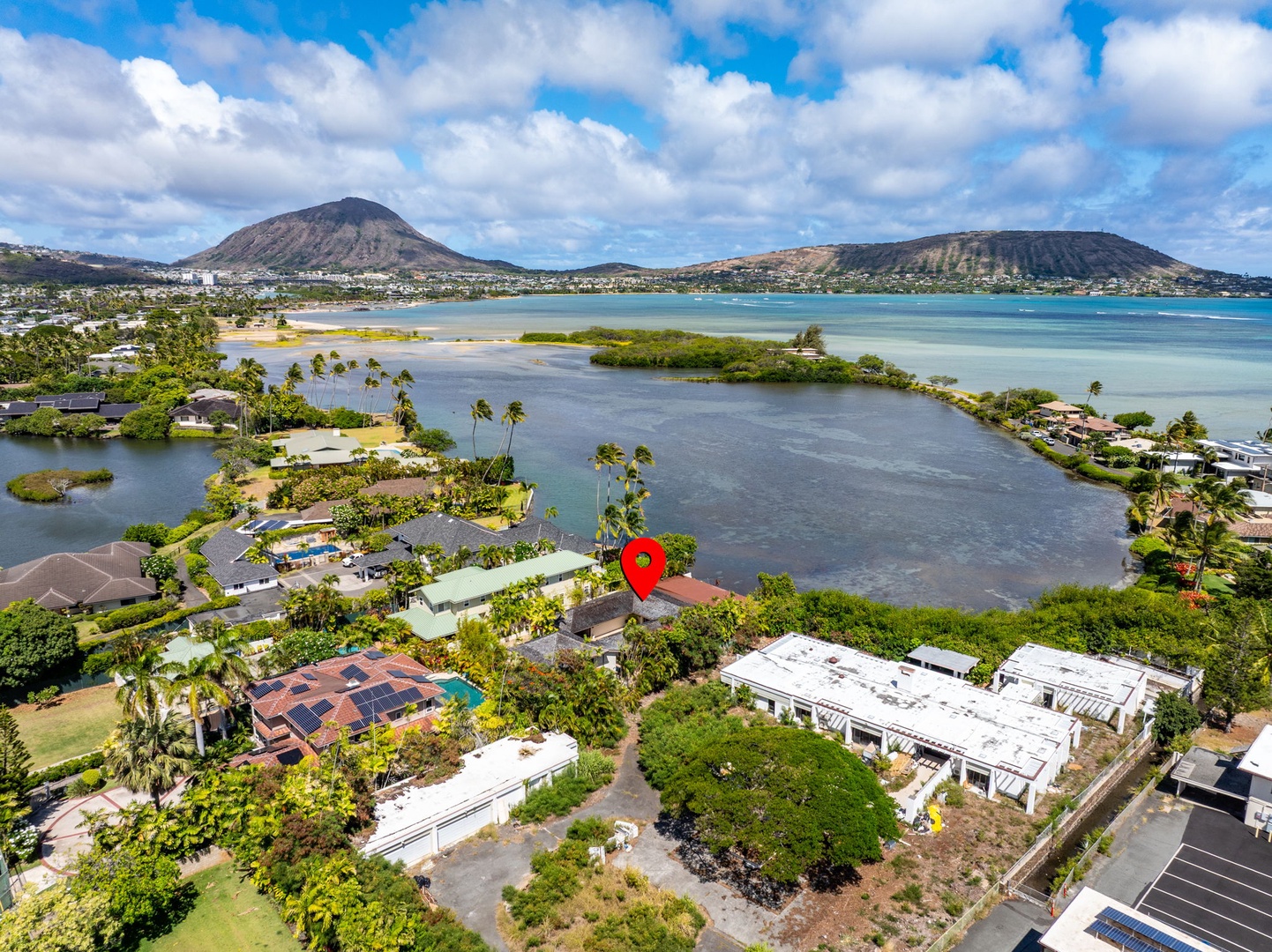 Honolulu Vacation Rentals, The Lagoon House 3BR - Wide aerial of lagoon, coastline, and homes set against dramatic volcanic hills.