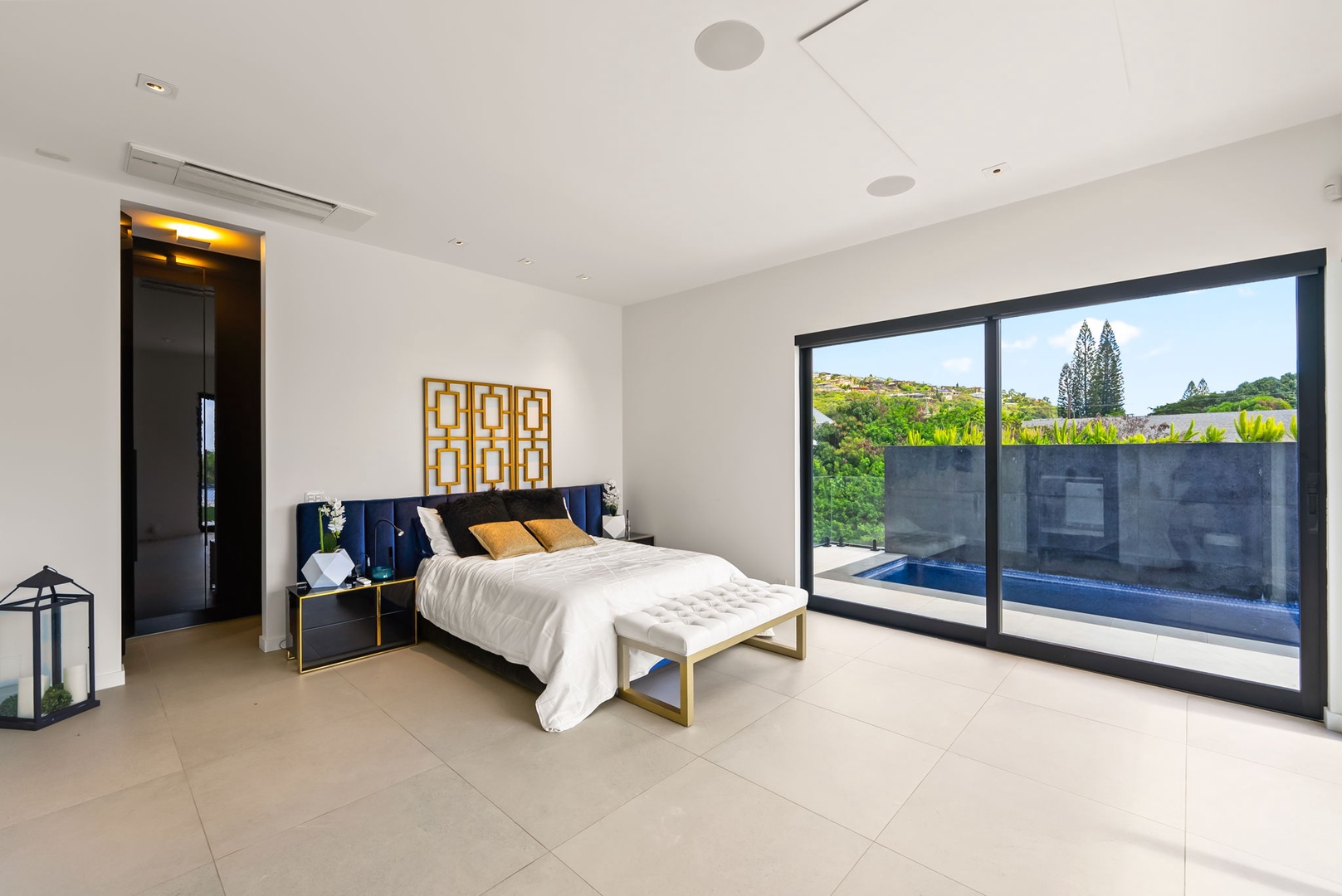 Honolulu Vacation Rentals, Ocean Villa Emilie - A peaceful lower-level bedroom with direct poolside access, offering a perfect blend of comfort and quiet privacy.