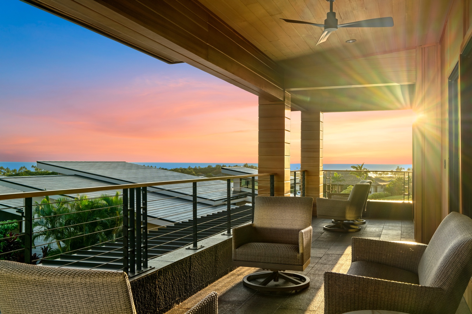 Koloa Vacation Rentals, Hale Laule'a at Kukui'ula - Unwind on your private terrace as golden sunlight bathes comfortable seating, offering stunning ocean views and tropical breezes.