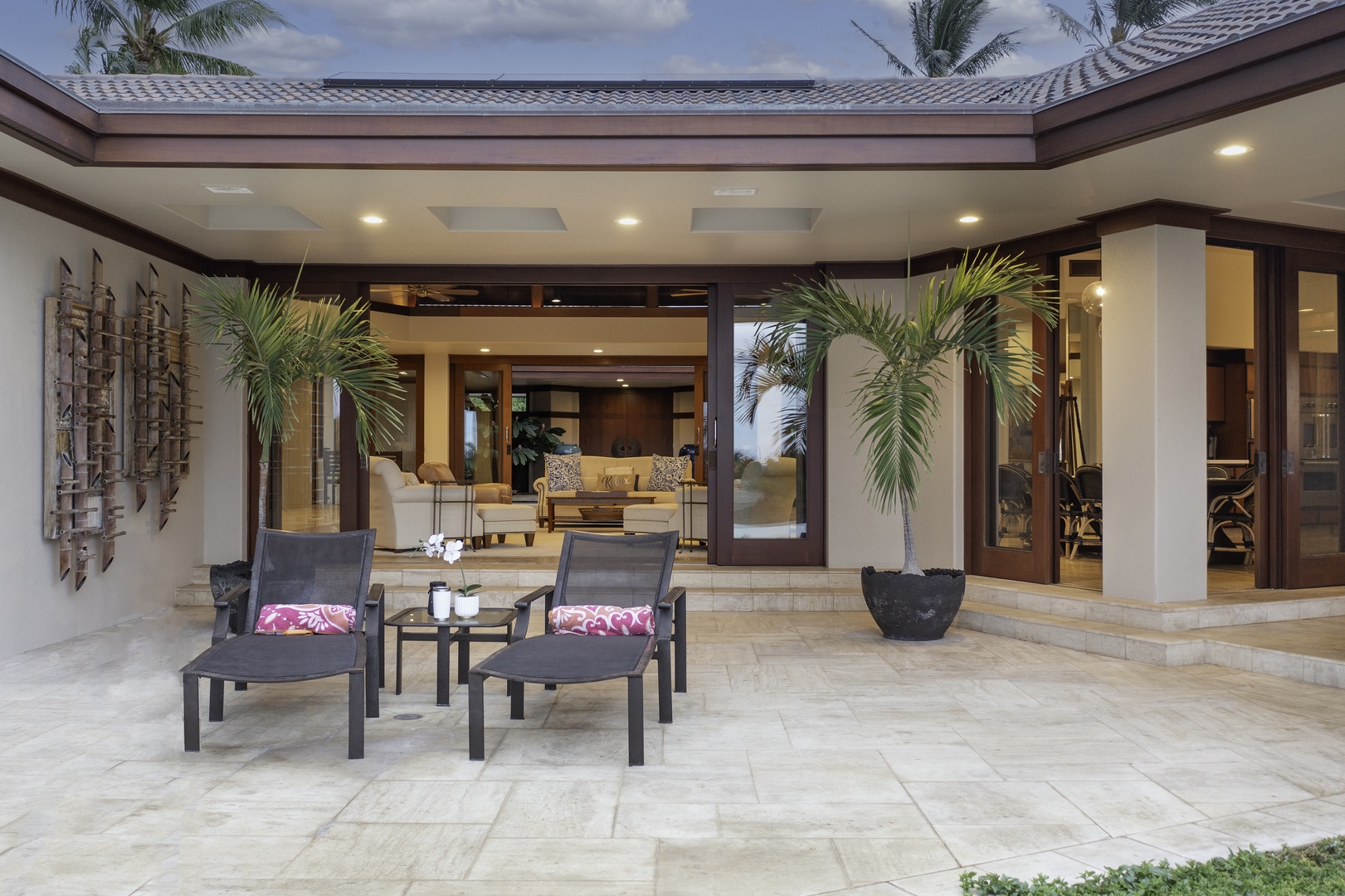 Kamuela Vacation Rentals, Champion Ridge 7 - Elegant covered terrace seamlessly connects indoor luxury with tropical outdoor living through sophisticated design and lush palm accents.