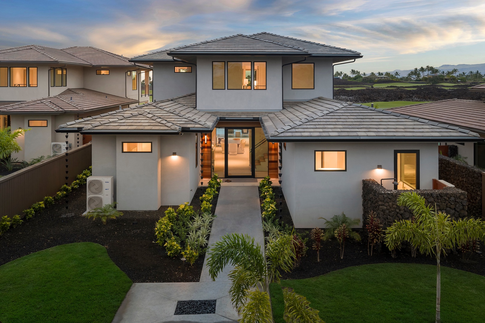 Kamuela Vacation Rentals, 6BD Mauna Lani Lux Golf Estate (6) at One Ocean - Lit from within, the home stands out among its neighbors as evening settles over the greens.
