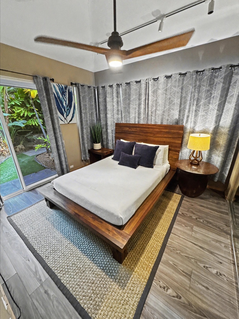 Kailua Kona Vacation Rentals, Hale Nai'a - Drift off to sleep in your stylish bedroom with plush bedding and warm wood accents, while tropical garden views create a peaceful retreat.