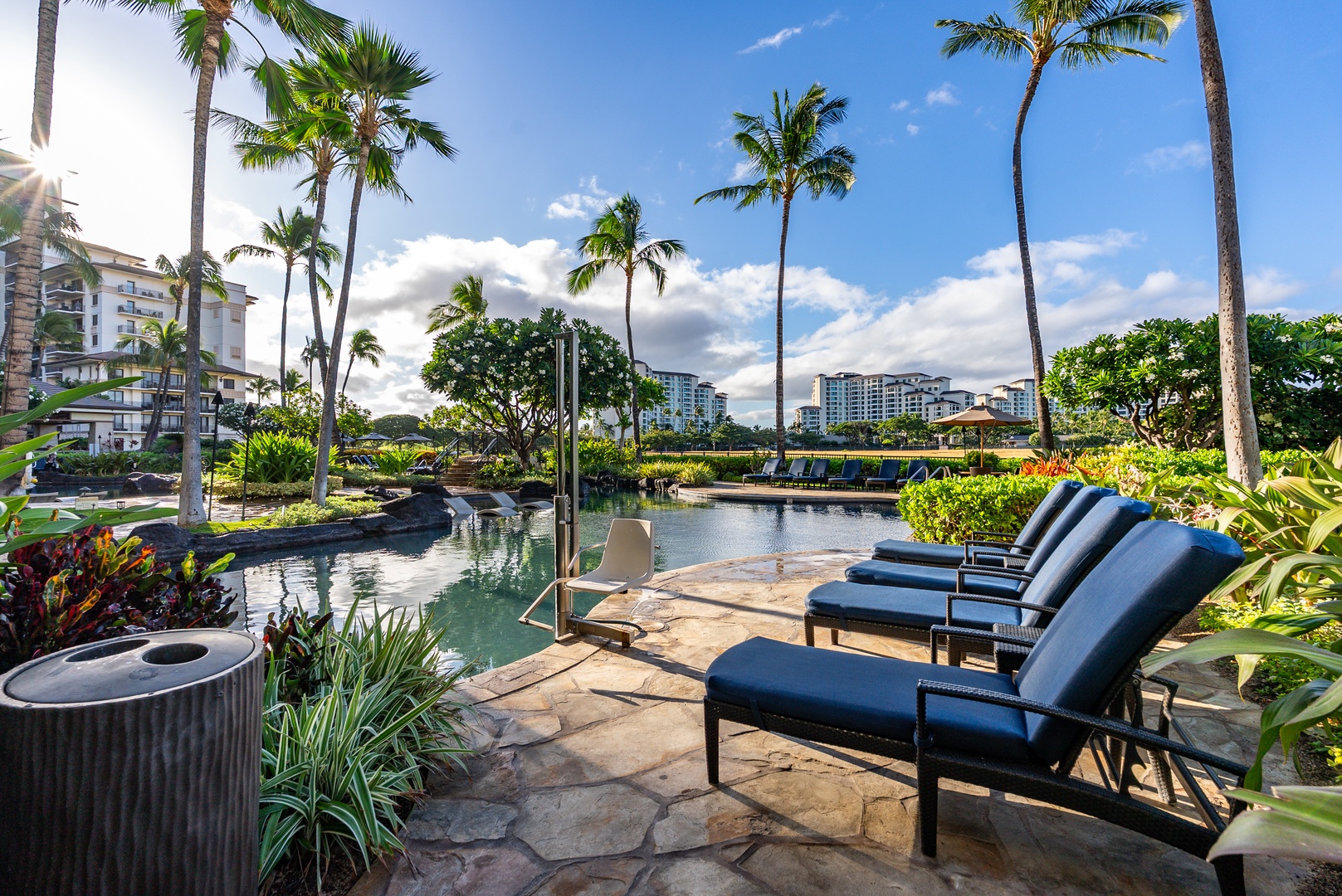 Line up on a lounger by the pool, greenery closing it in.