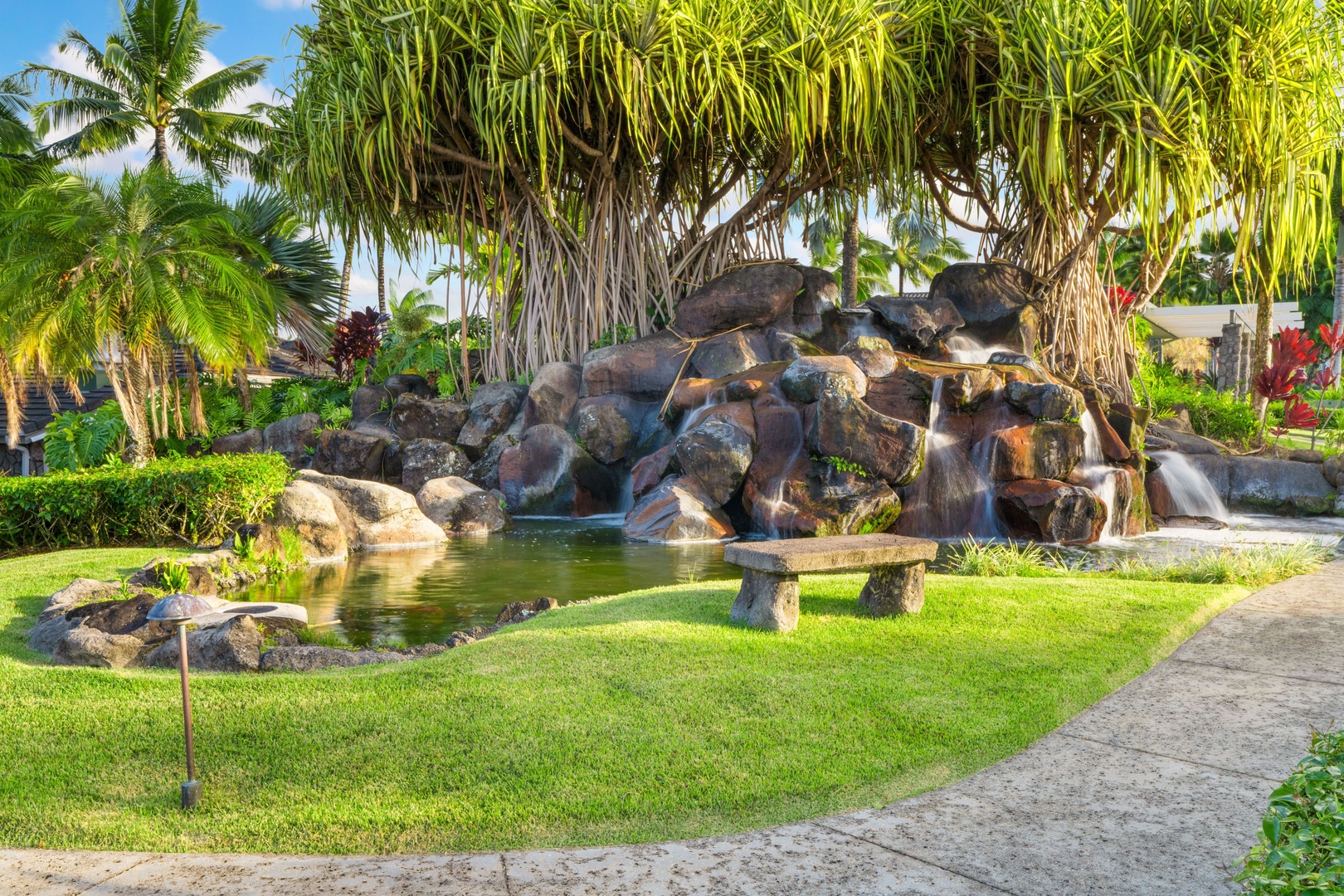 Princeville Vacation Rentals, Tropical Elegance - Experience the harmony of nature in our immaculately kept garden, a sanctuary of lush greenery, pond, and blooming flowers.