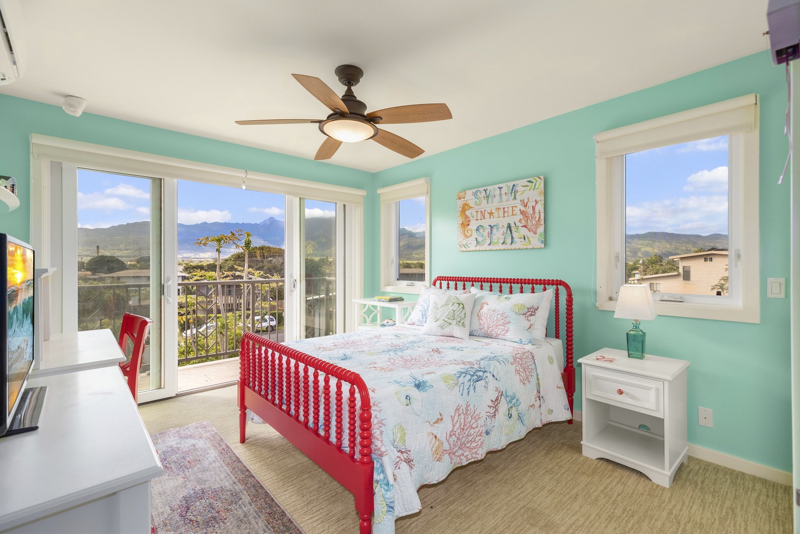 Waialua Vacation Rentals, Waialua Beachfront Getaway - Bedroom with lanai, view of the mountains, and Jack-and-Jill attached bathroom.