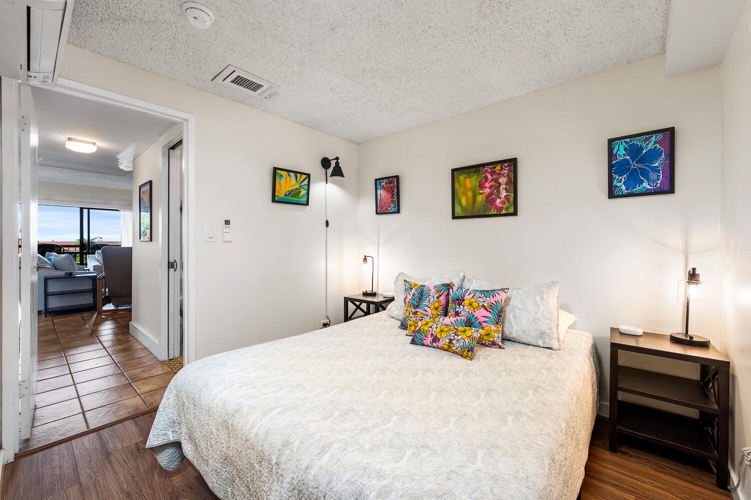 Kailua Kona Vacation Rentals, Kona Plaza 201 - Sink into your cozy bed surrounded by vibrant tropical artwork and modern touches for the perfect restful retreat.