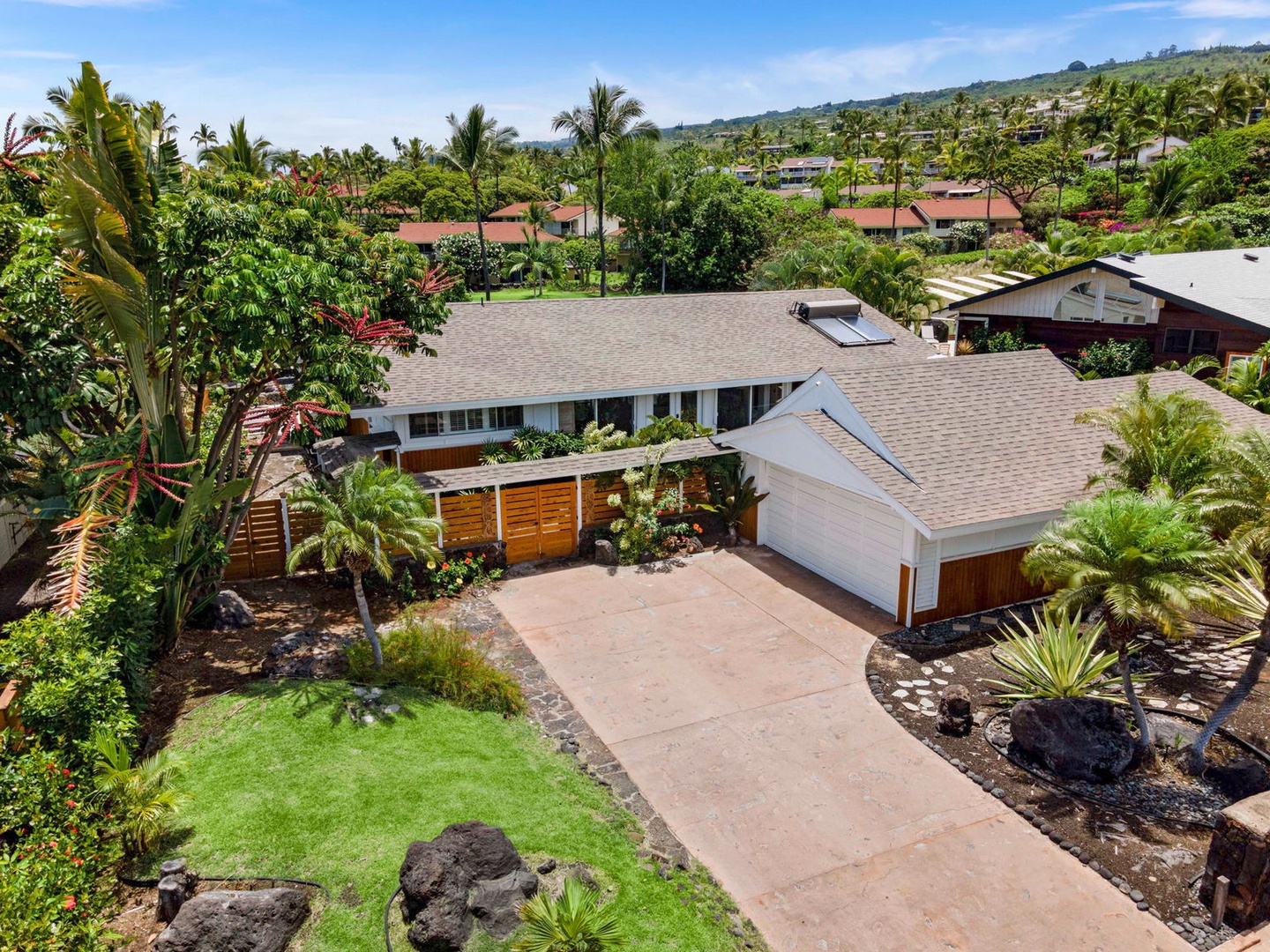 Kailua Kona Vacation Rentals, Manukai Hale - The drive and grounds open up from above, palms shading the approach.