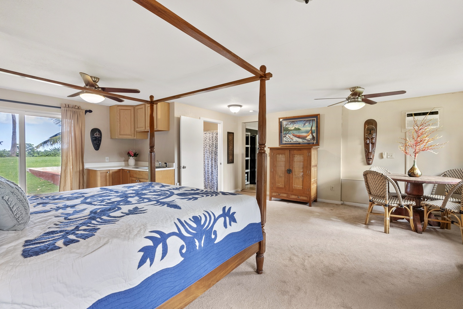 Haleiwa Vacation Rentals, North Shore Beachfront Resort - Inviting bedroom featuring a king-size bed and lush garden views.