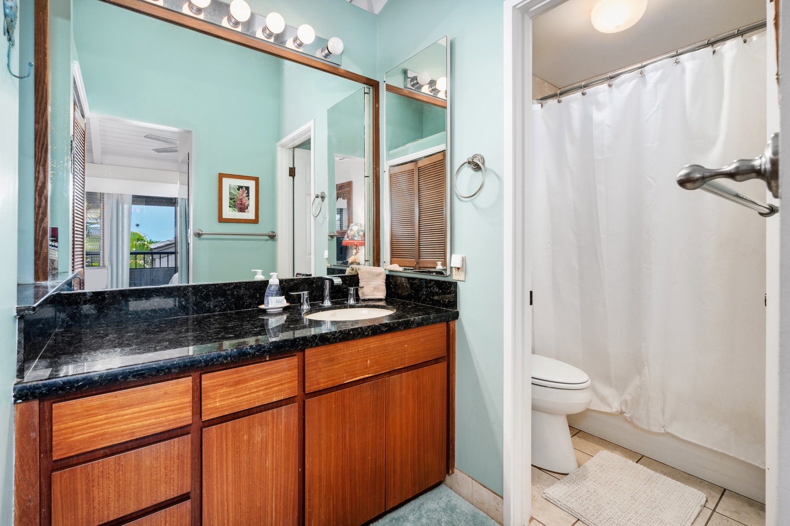 Kihei Vacation Rentals, Wailea Ekolu 204 - The vanity mirror catches a glimpse of the lanai just down the hall, so getting ready still faces the day outside.