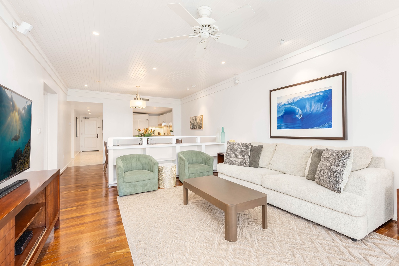 Kahuku Vacation Rentals, Turtle Bay Villas 209 - Elegant living space with coastal artwork, plush seating, and an open layout that flows to your modern kitchen.