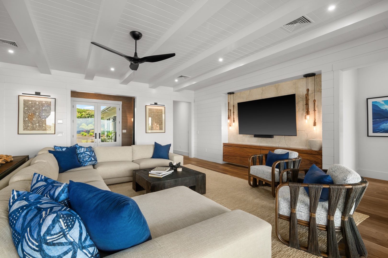 Koloa Vacation Rentals, Makani Kai - Movie night has a home here, the screen mounted above built-ins framed in warm wood.