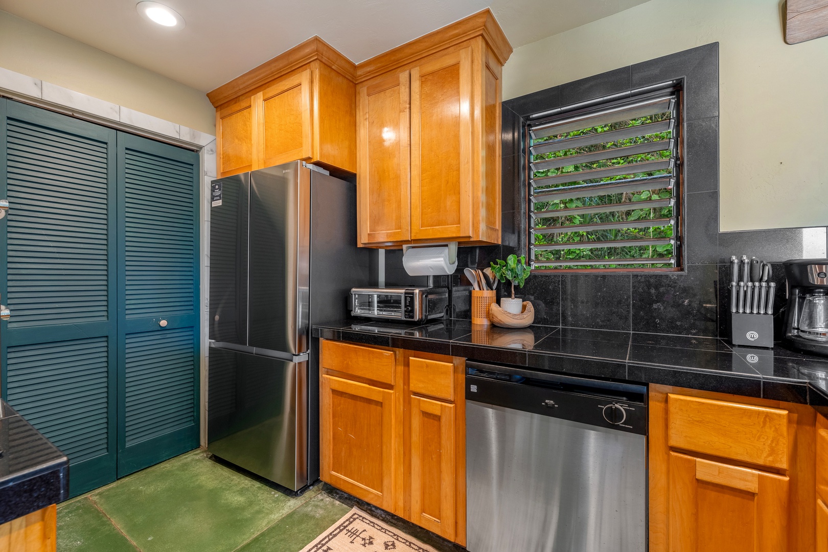 Hanalei Vacation Rentals, Hale Kepuhi - Your fully equipped kitchen features warm wood cabinets and a perfect setting for preparing delicious meals during your stay.