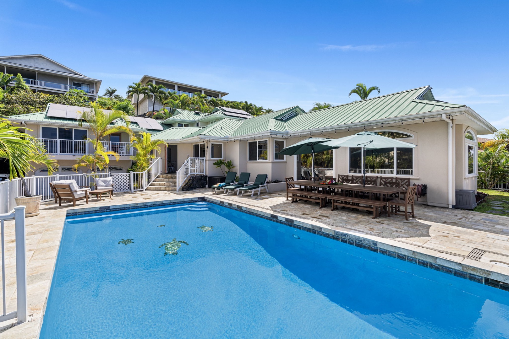 Kailua-Kona Vacation Rentals, Honu Hale - Tropical villa with private pool surrounded by lush palms under clear blue skies in a peaceful hillside setting.