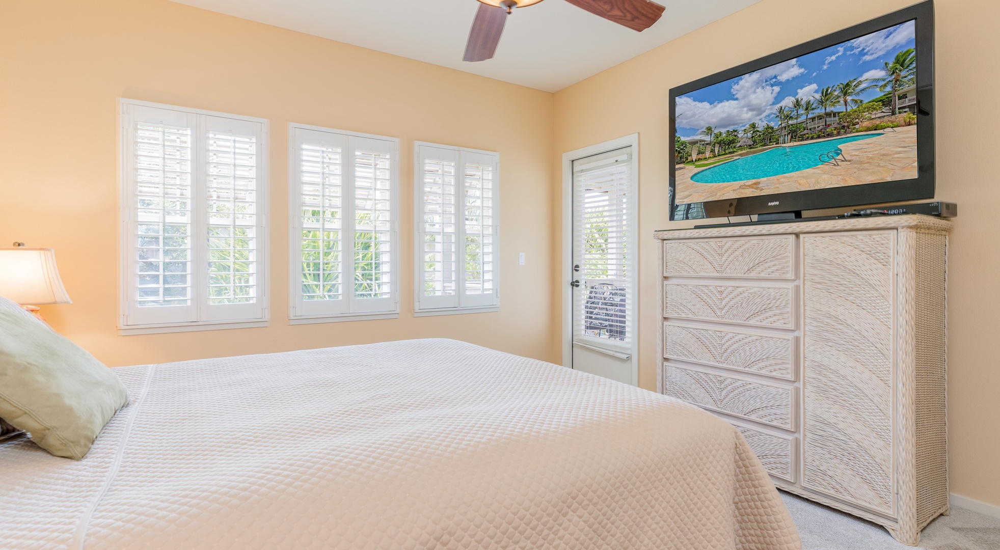 Kapolei Vacation Rentals, Coconut Plantation 1192-4 - The primary guest bedroom with lanai access and a TV.