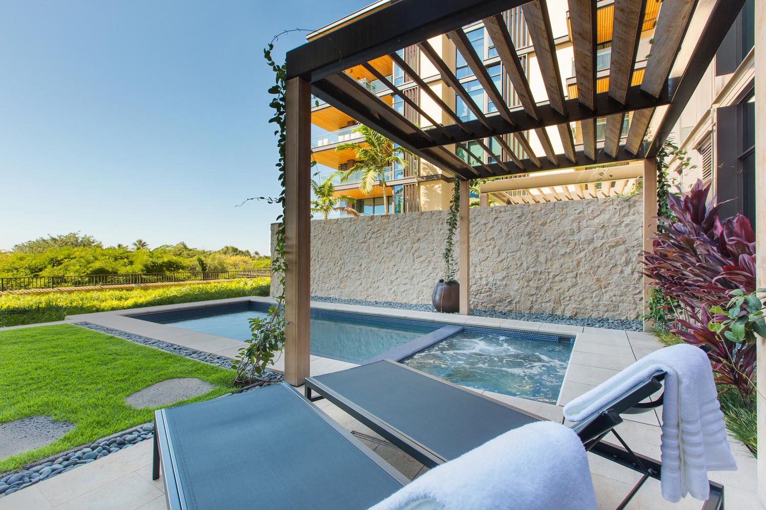 Honolulu Vacation Rentals, Park Lane Sunset Resort - Unwind in a sparkling pool, bubbling hot tub, and comfortable loungers under a stylish pergola.