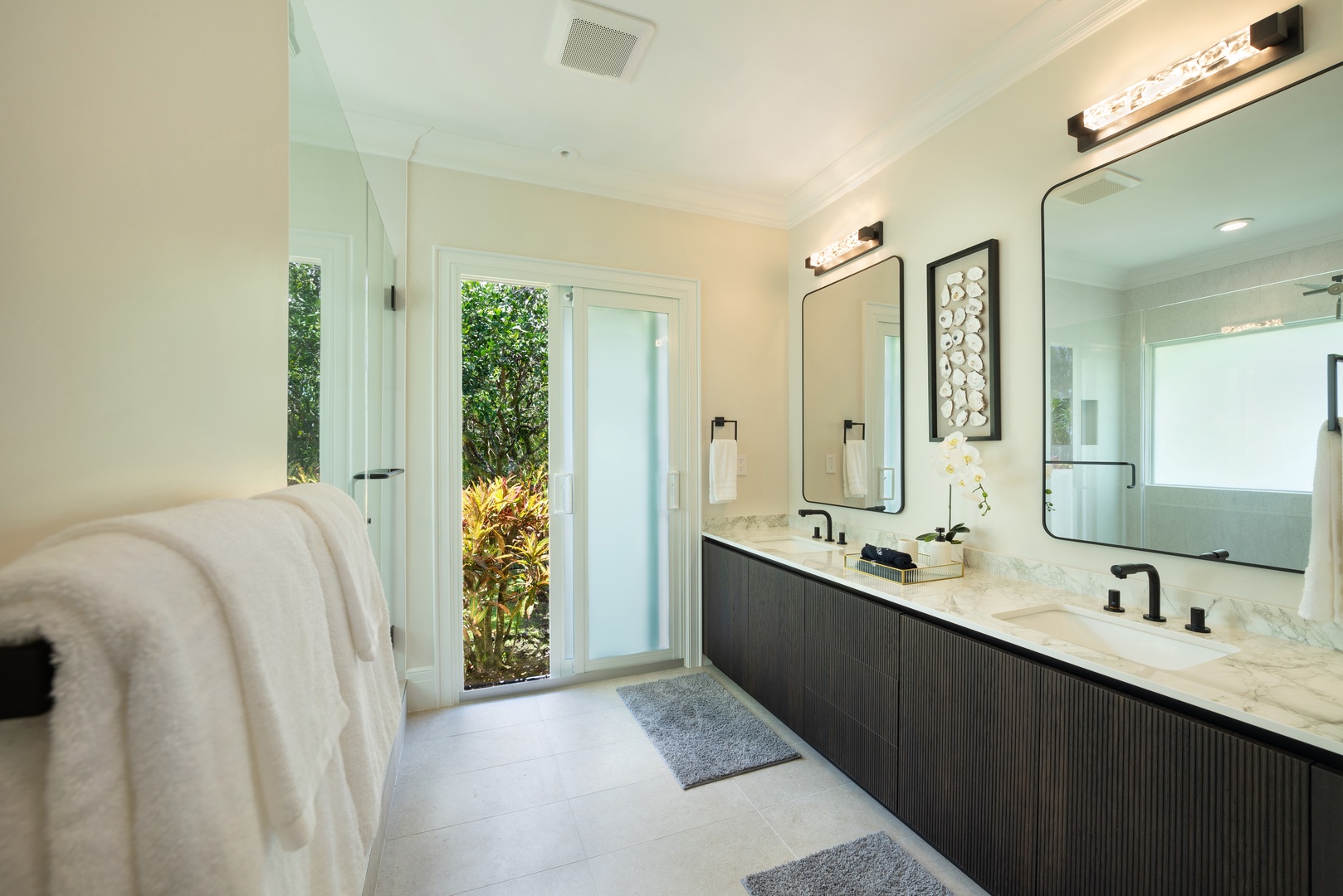 Princeville Vacation Rentals, Hihimanu House - Elegant bathroom with double sinks, a large mirror, and garden views.