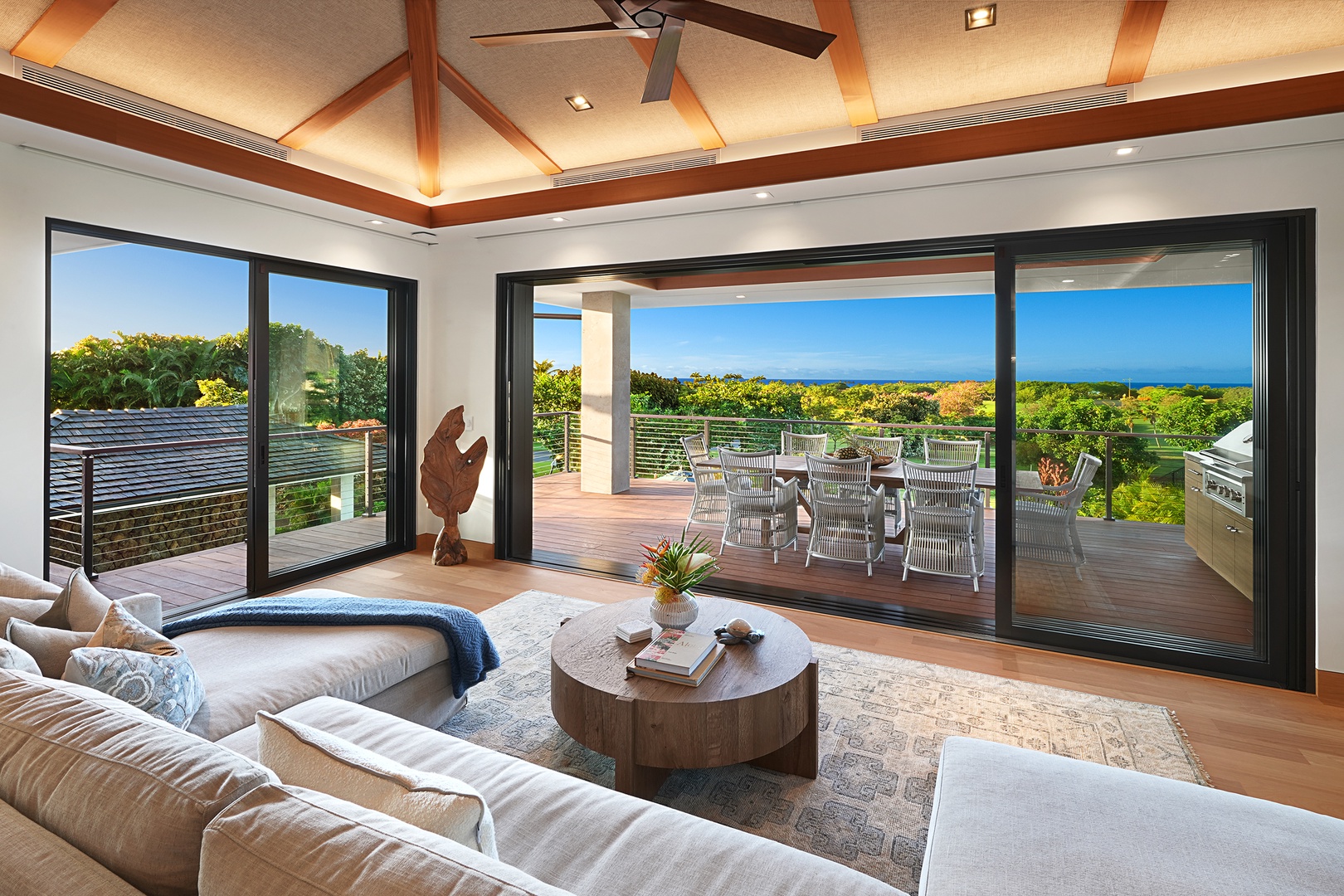 Koloa Vacation Rentals, Hale Kai'Opua - Relax in the cozy living room with expansive glass doors opening to serene outdoor views.