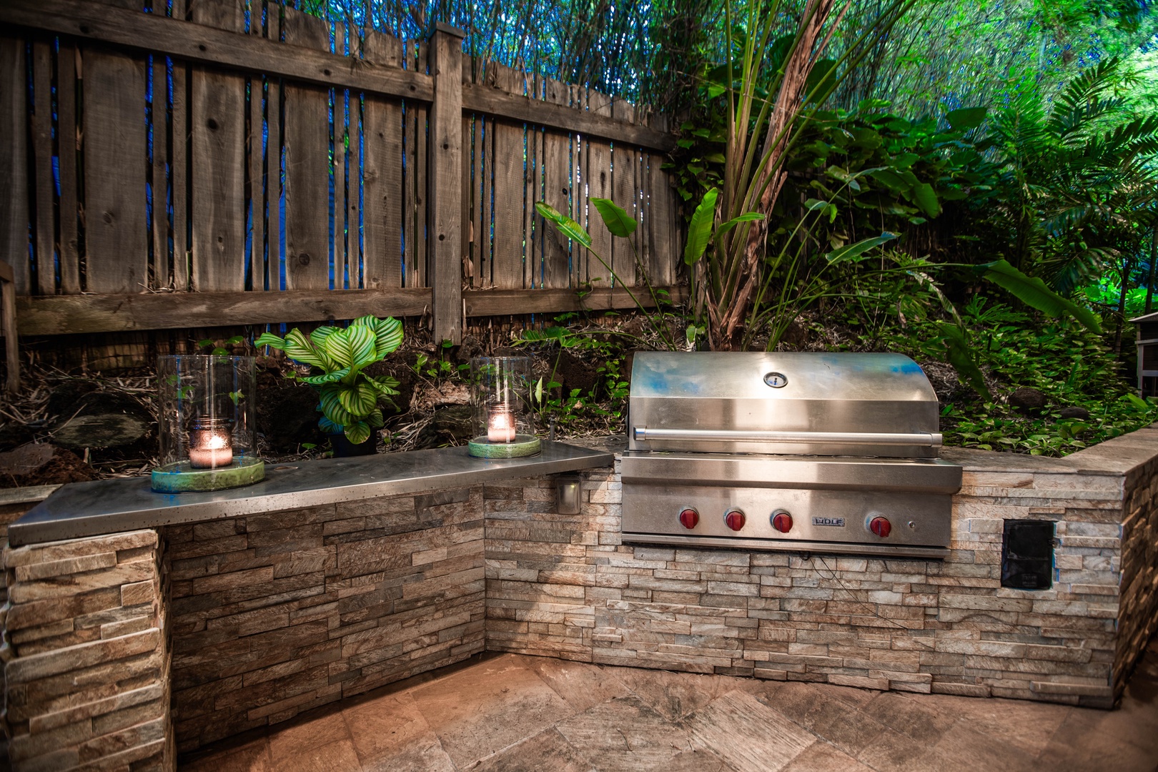Honolulu Vacation Rentals, Pili Pono - Built-in gas grill with stone walls and ambient lighting.