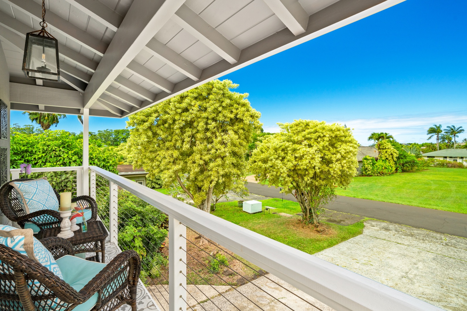 Princeville Vacation Rentals, Ola Hou - Main House - Sip your morning coffee while enjoying serene views of the lush landscape.