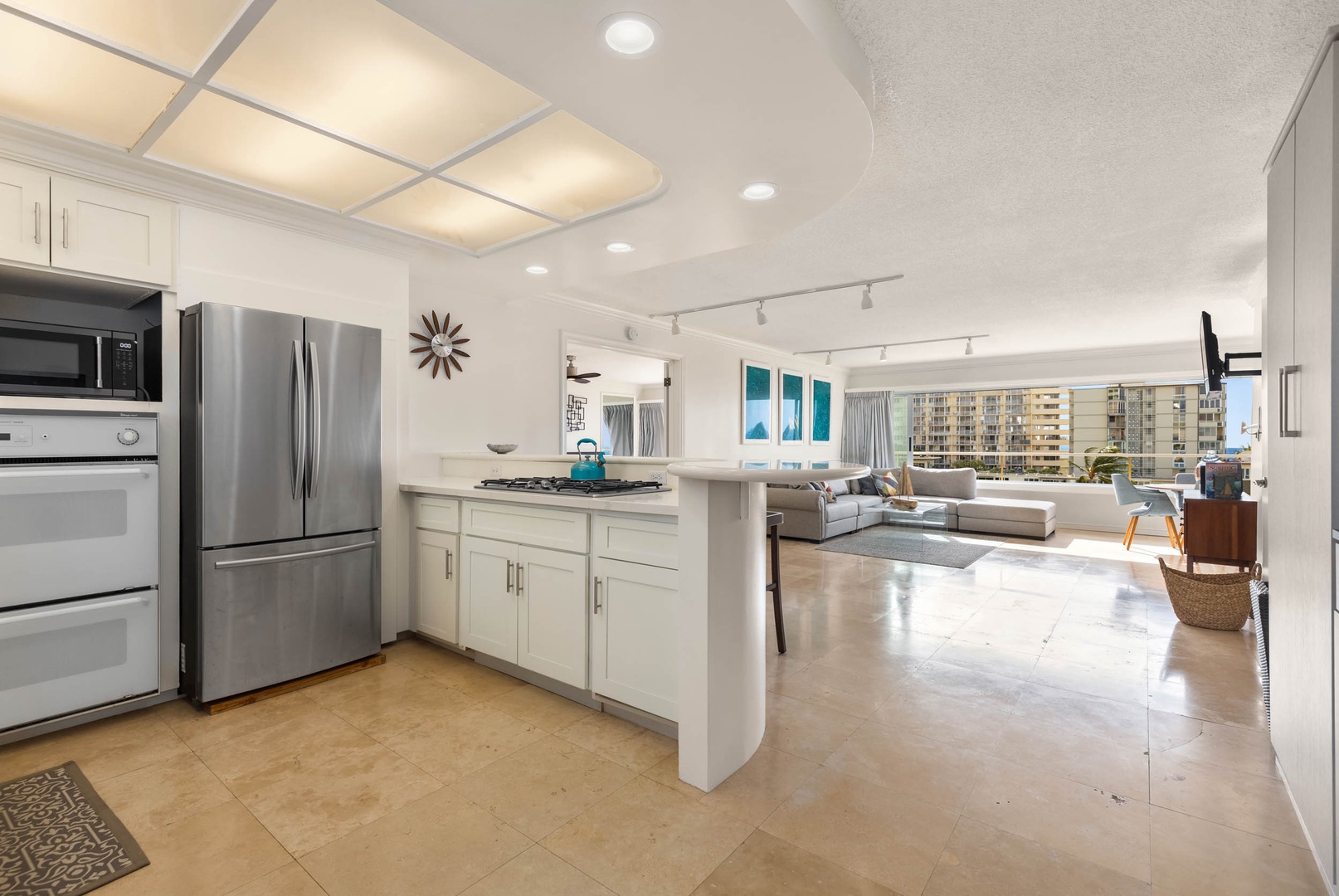 Honolulu Vacation Rentals, Colony Surf Getaway - Sleek, fully-equipped kitchen that opens up to a luxurious living space, perfect for entertaining or leisure.