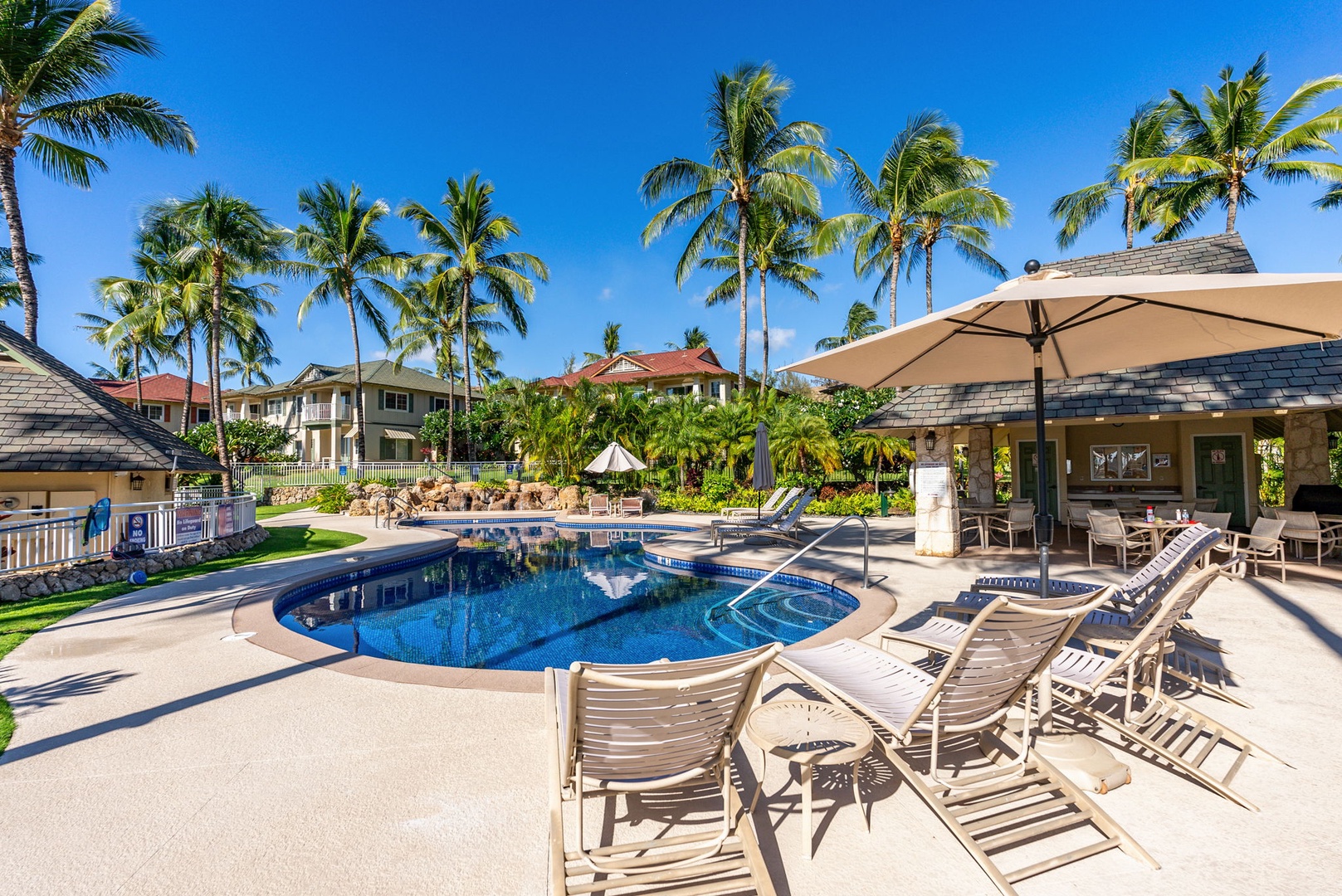 Kapolei Vacation Rentals, Kai Lani Luxury 6D - Pool area featuring lounge chairs and umbrellas, designed for ultimate relaxation under the Hawaiian sun.