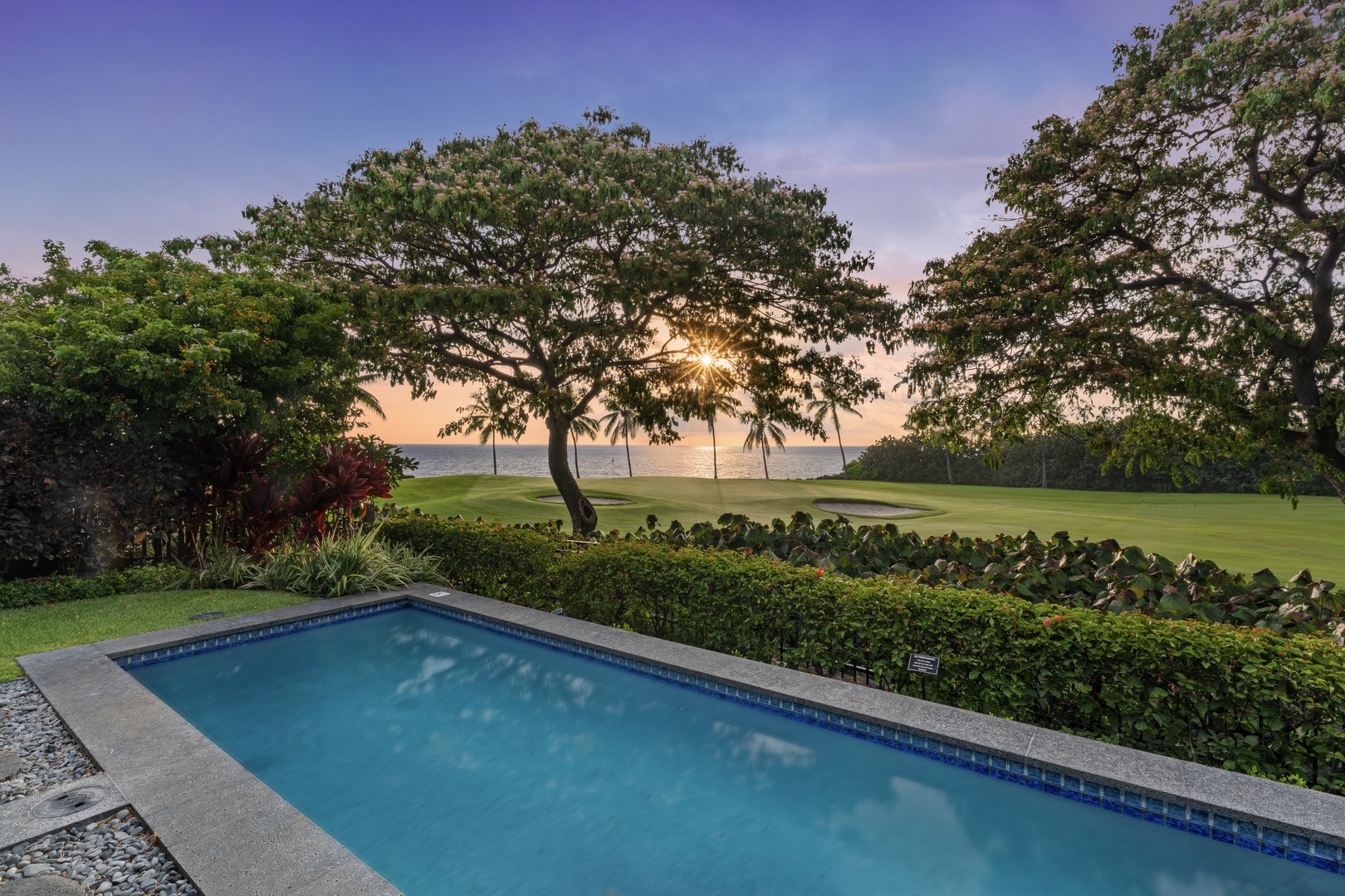 Kailua Kona Vacation Rentals, Holua Kai #27 - The pool lights up as evening settles over the fairway and the palms go dark.