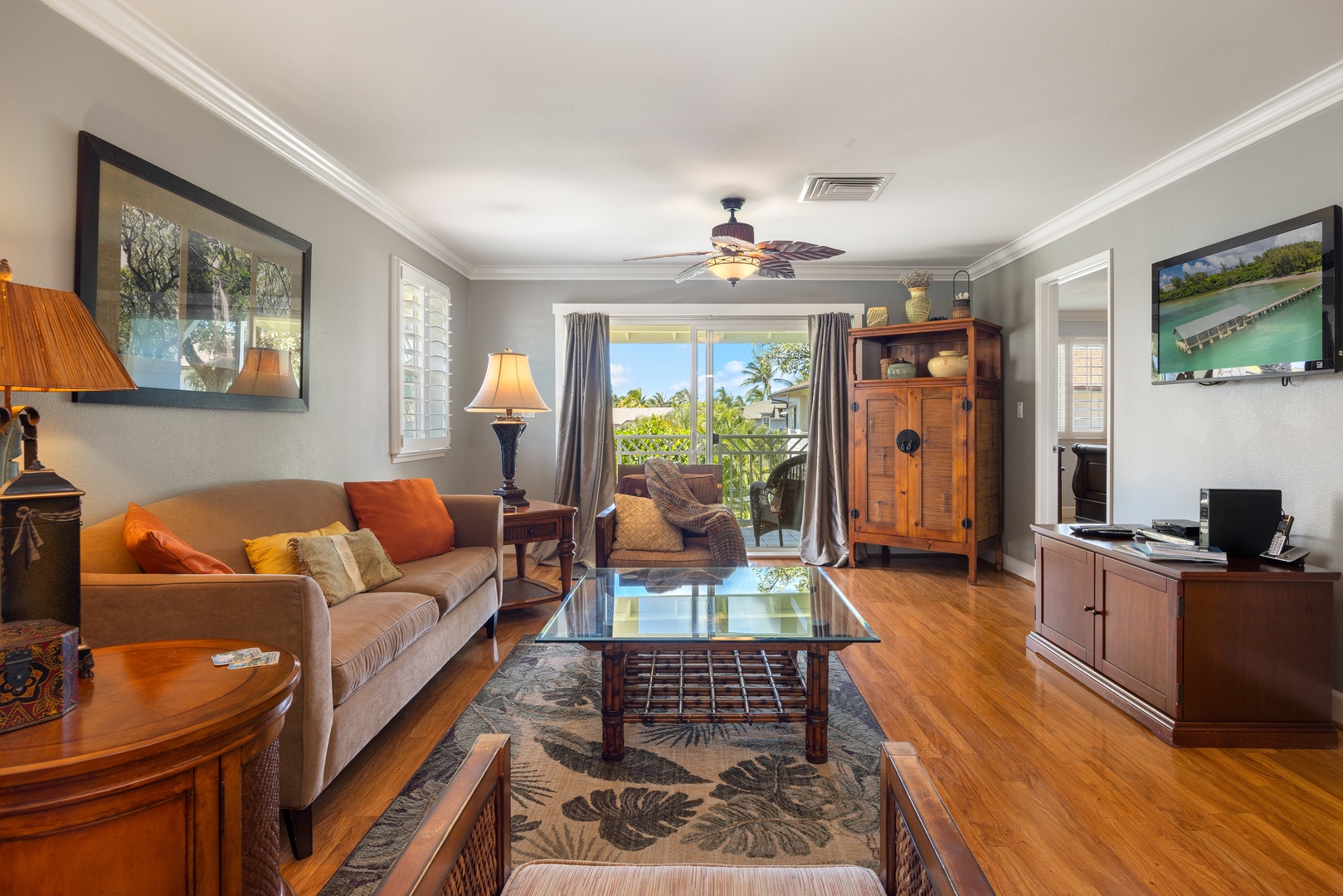Sink into this comfortable living room where tropical breezes flow through sliding doors to your private lanai overlooking lush gardens.