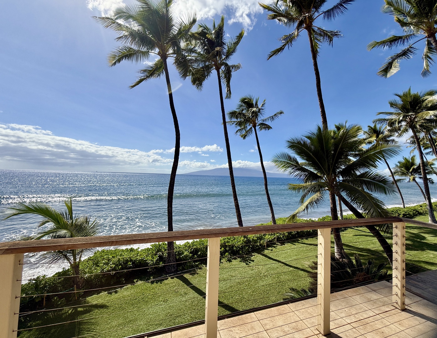 Lahaina Vacation Rentals, Puamana 254-2 - Relax on the lanai with stunning ocean and palm views just steps away.