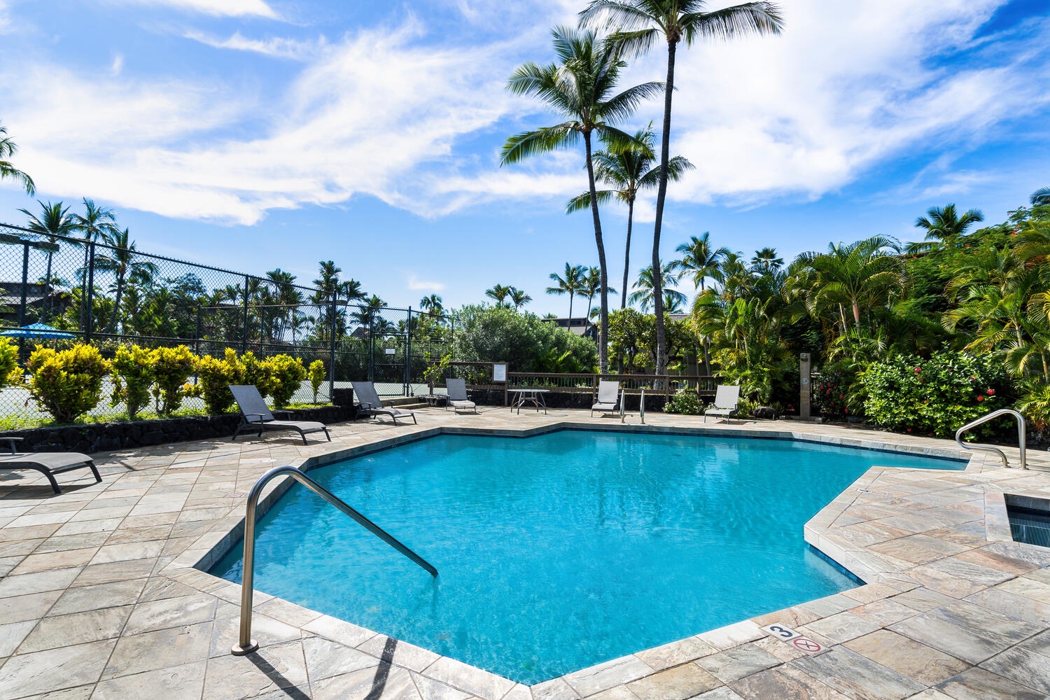 Kailua Kona Vacation Rentals, Kanaloa at Kona 3303 - Large shared pool with loungers and blue skies.