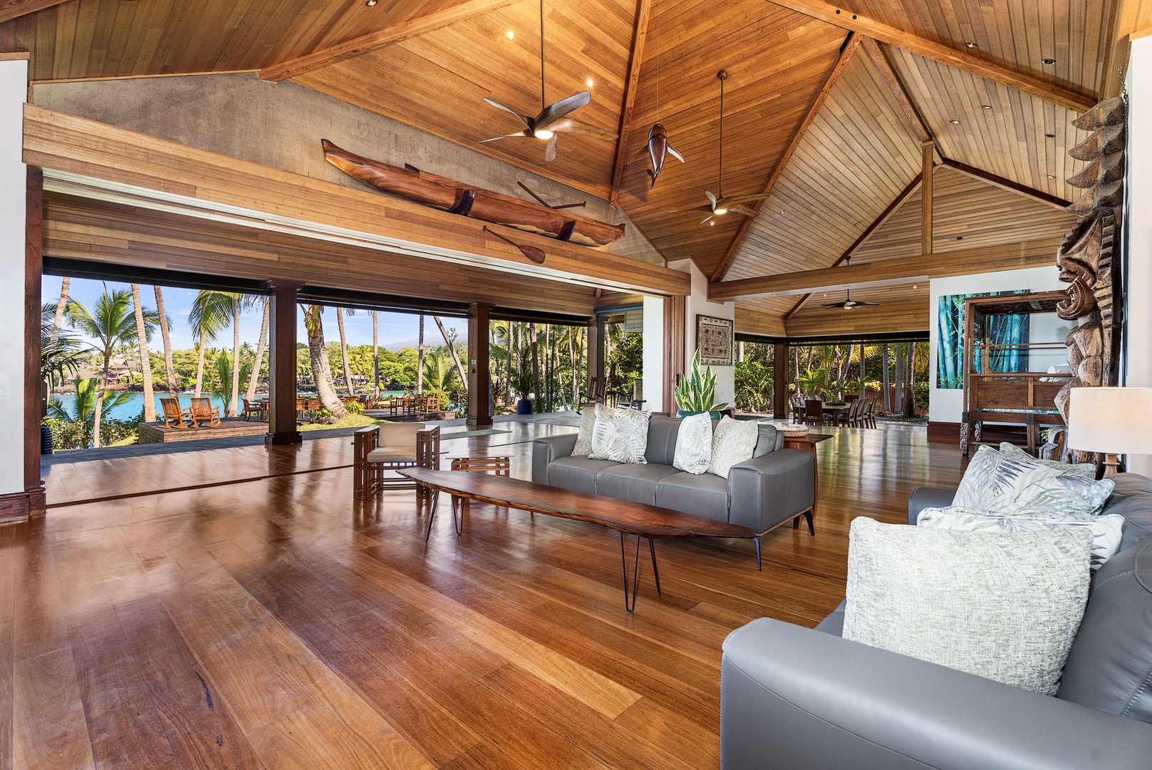 Kailua-Kona Vacation Rentals, Hahalua Bay Villa - Relax in your stunning living room with vaulted wood ceilings, tropical views, and modern furnishings that blend seamlessly with the natural surroundings.