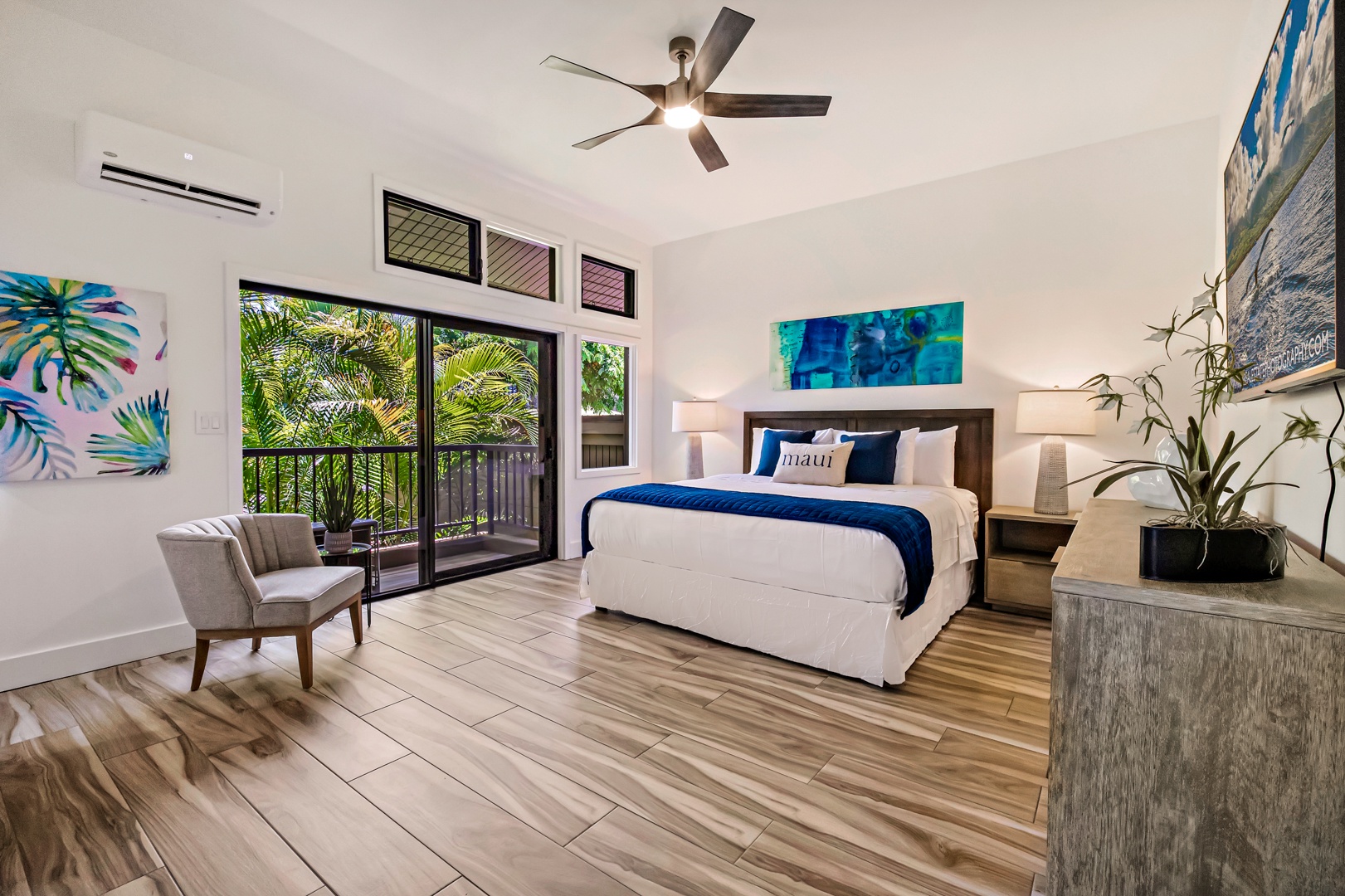 Lahaina Vacation Rentals, Kapalua Ridge 1421 - The spacious primary bedroom features a king-sized bed and direct access to a private lanai, offering a peaceful retreat with lush garden views.