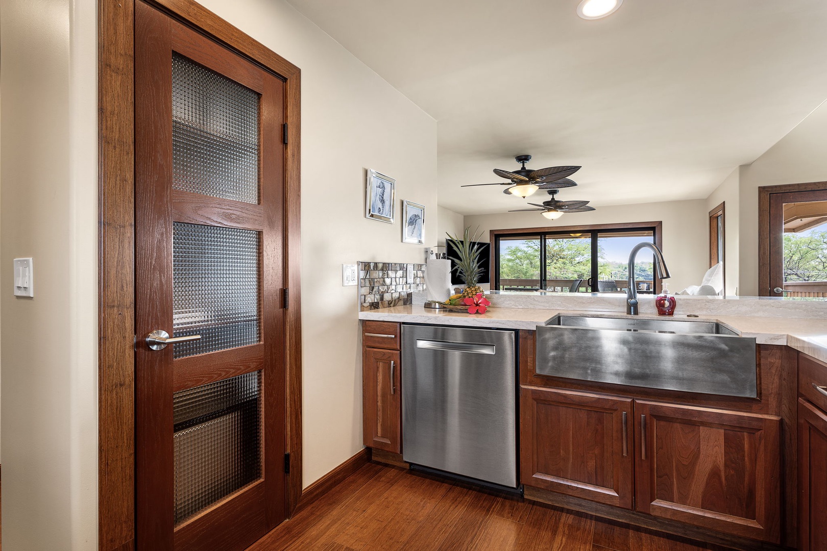 Kailua Kona Vacation Rentals, Royal Kahili 401A - Modern kitchen with rich wood cabinetry, stainless steel appliances, and ample counter space.