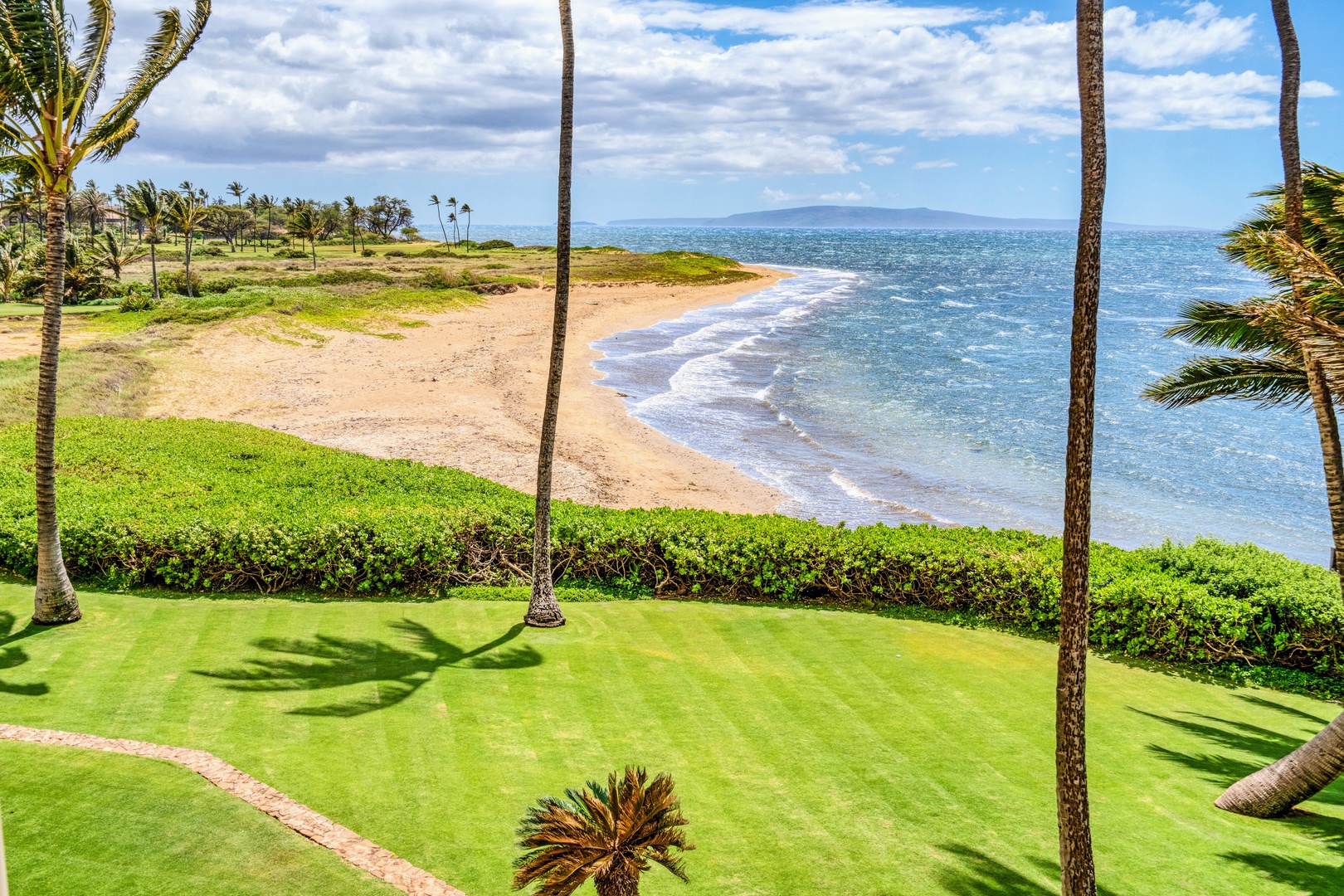 Kihei Vacation Rentals, Menehune Shores 316 - The lawn rolls right into a wide, empty stretch of sand made for slow mornings.