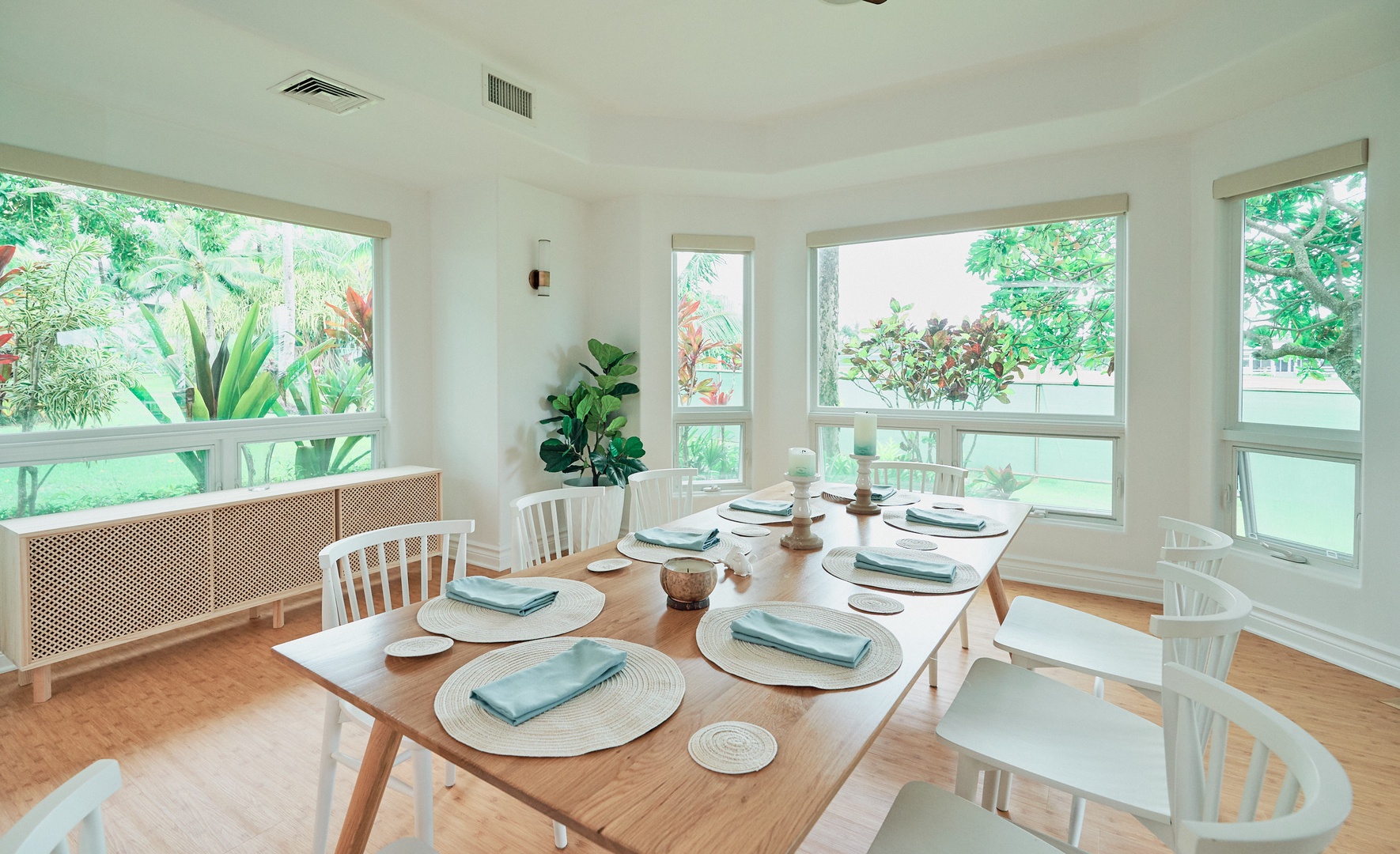 Princeville Vacation Rentals, Hale Kai - Your bright dining space overlooks lush tropical gardens through floor-to-ceiling windows, creating the perfect backdrop for memorable meals together.