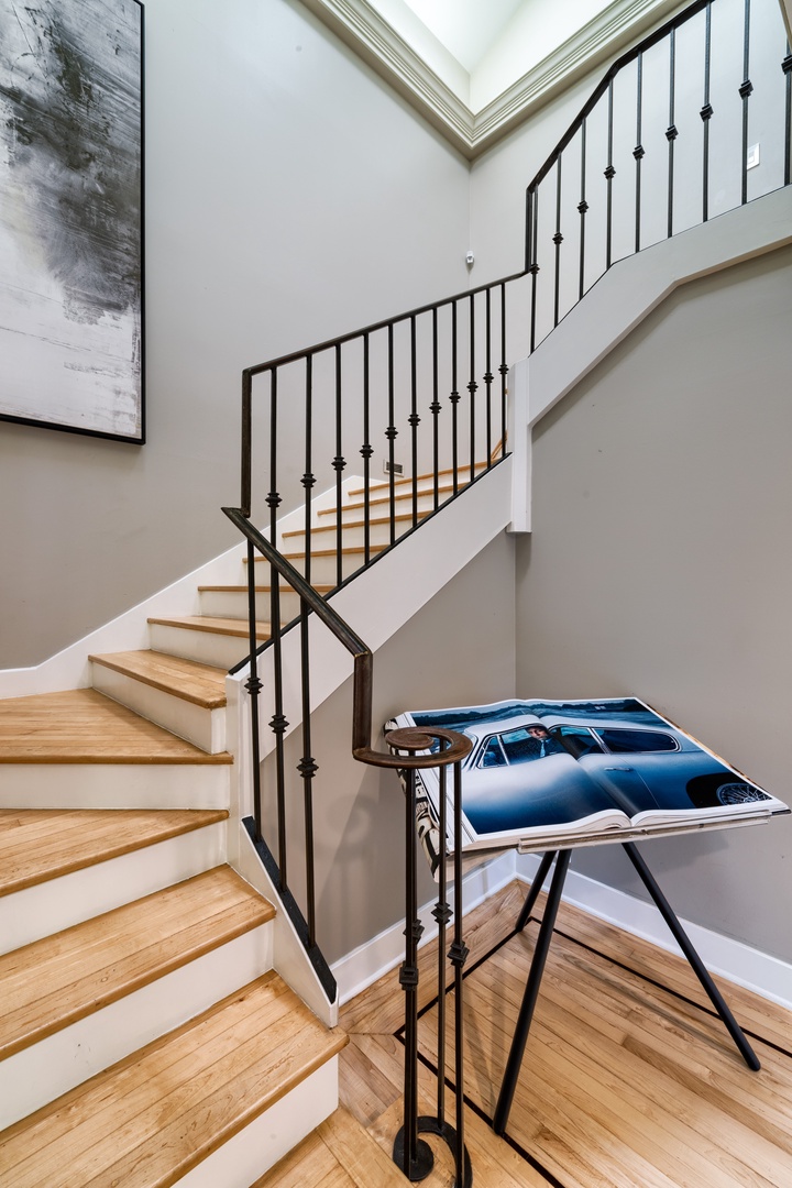 Honolulu Vacation Rentals, Moana Lani - The main staircase leading to both primary suites and bedroom 1, with two queen beds.