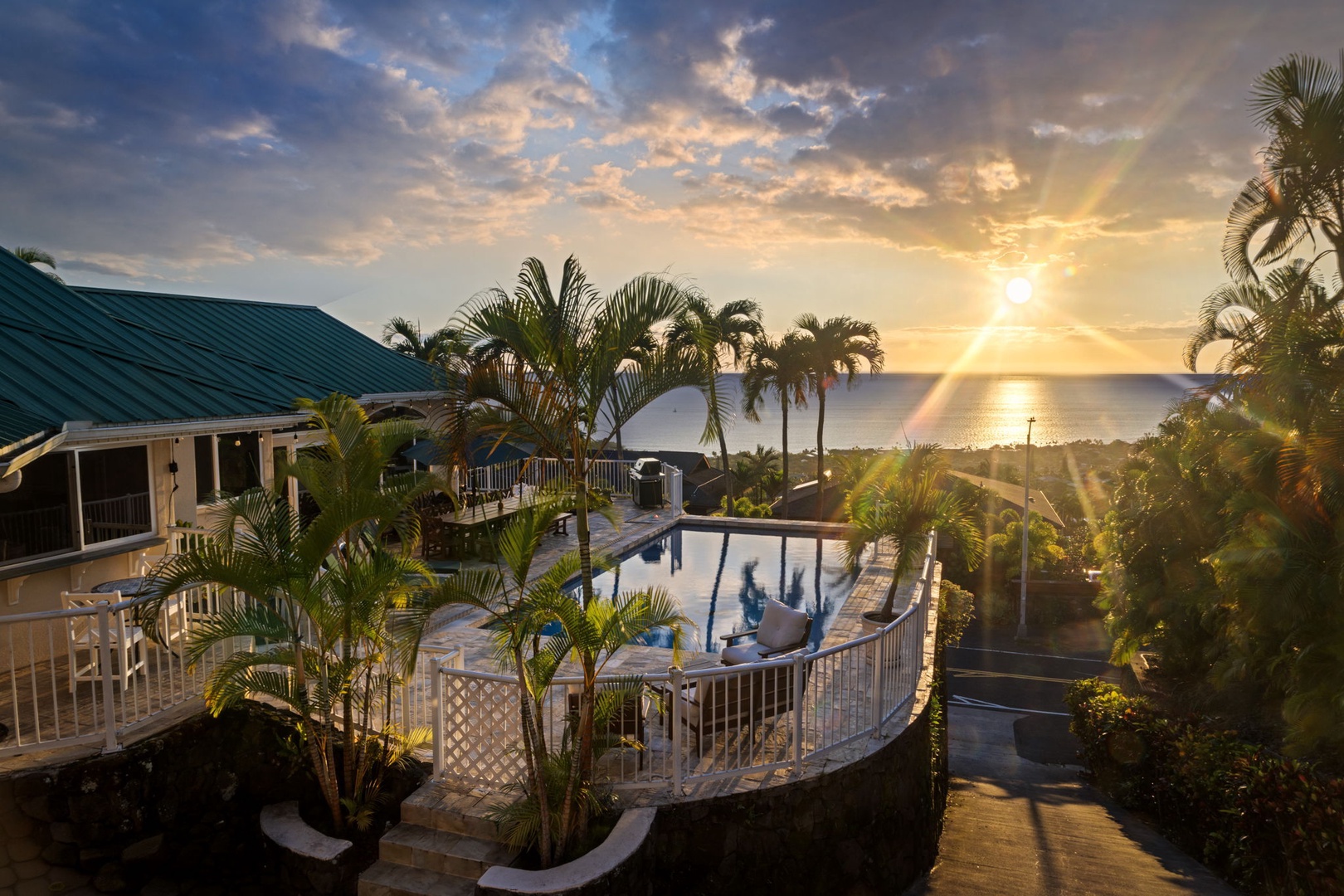 Kailua-Kona Vacation Rentals, Honu Hale - Tropical paradise property with stunning ocean views and golden sunset lighting over the surrounding landscape.