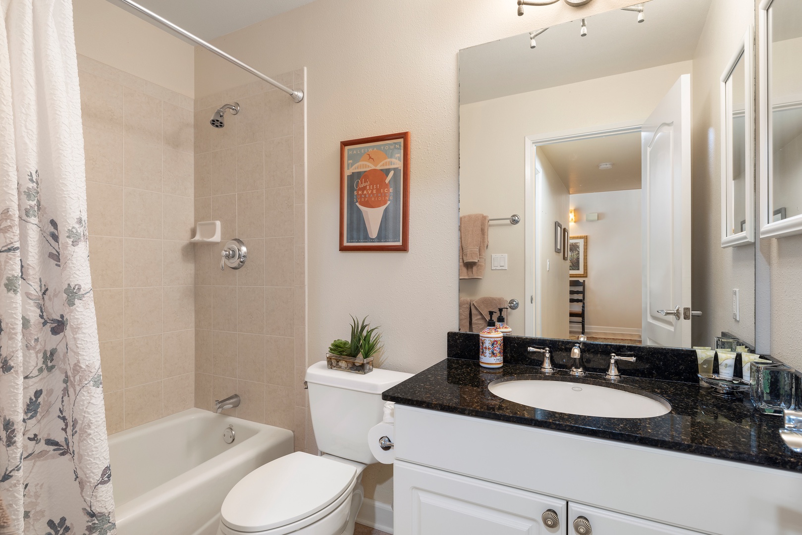 Your private bathroom features a relaxing tub-shower combo with granite countertops and thoughtful touches like fresh greenery to make you feel at home.