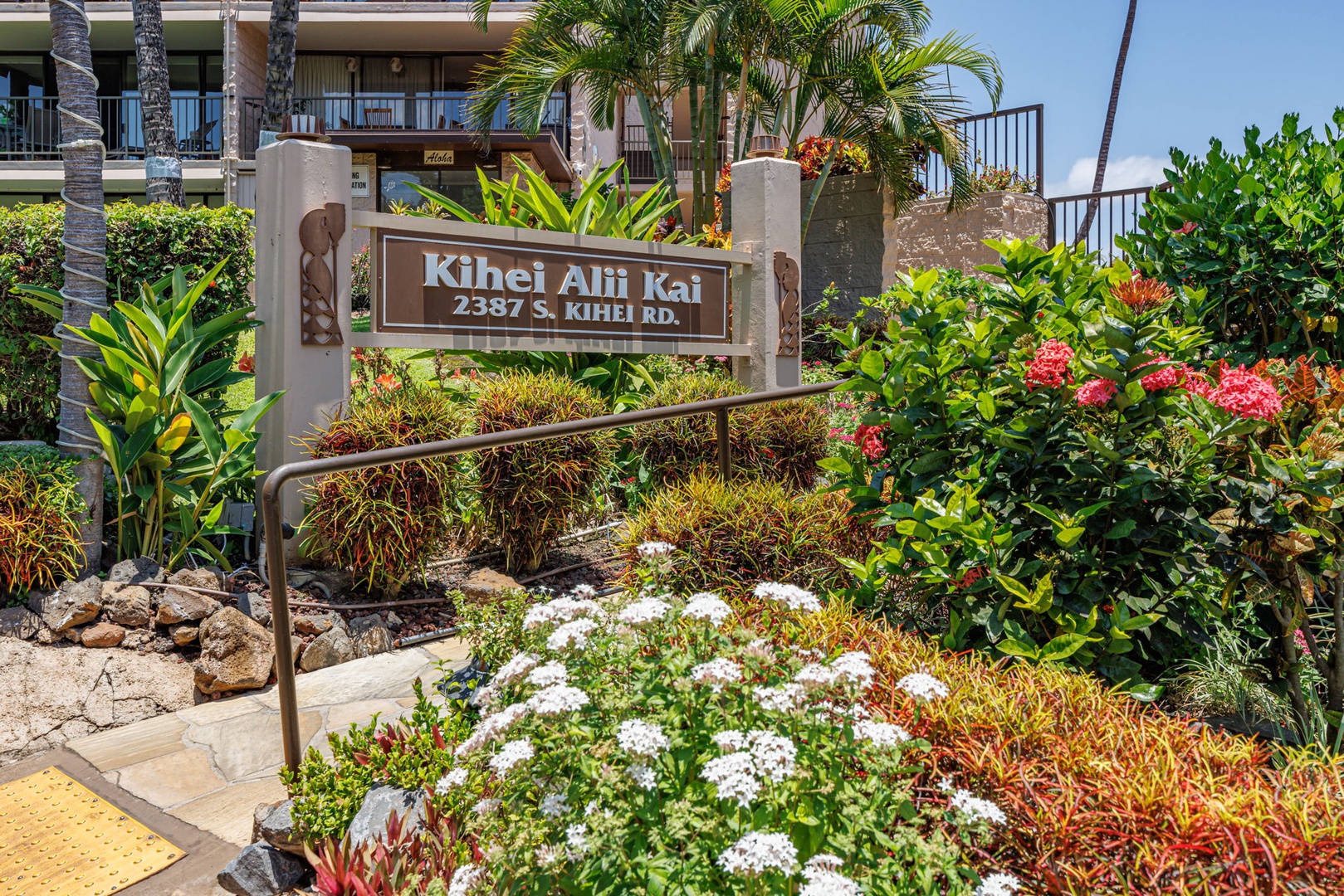 Kihei Vacation Rentals, Kihei Alii Kai C206 - Kihei Alii Kai from the street, the entrance in croton and flowering hedges.