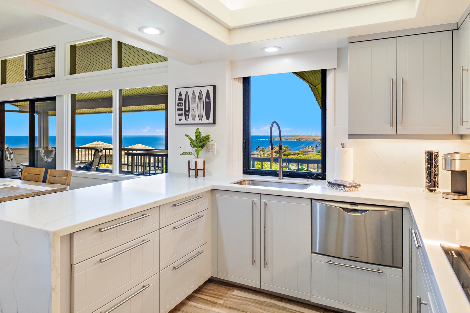 Lahaina Vacation Rentals, Kapalua Ridge 1421 - The modern kitchen features sleek cabinetry and a breathtaking ocean view, making it the perfect spot to prepare meals