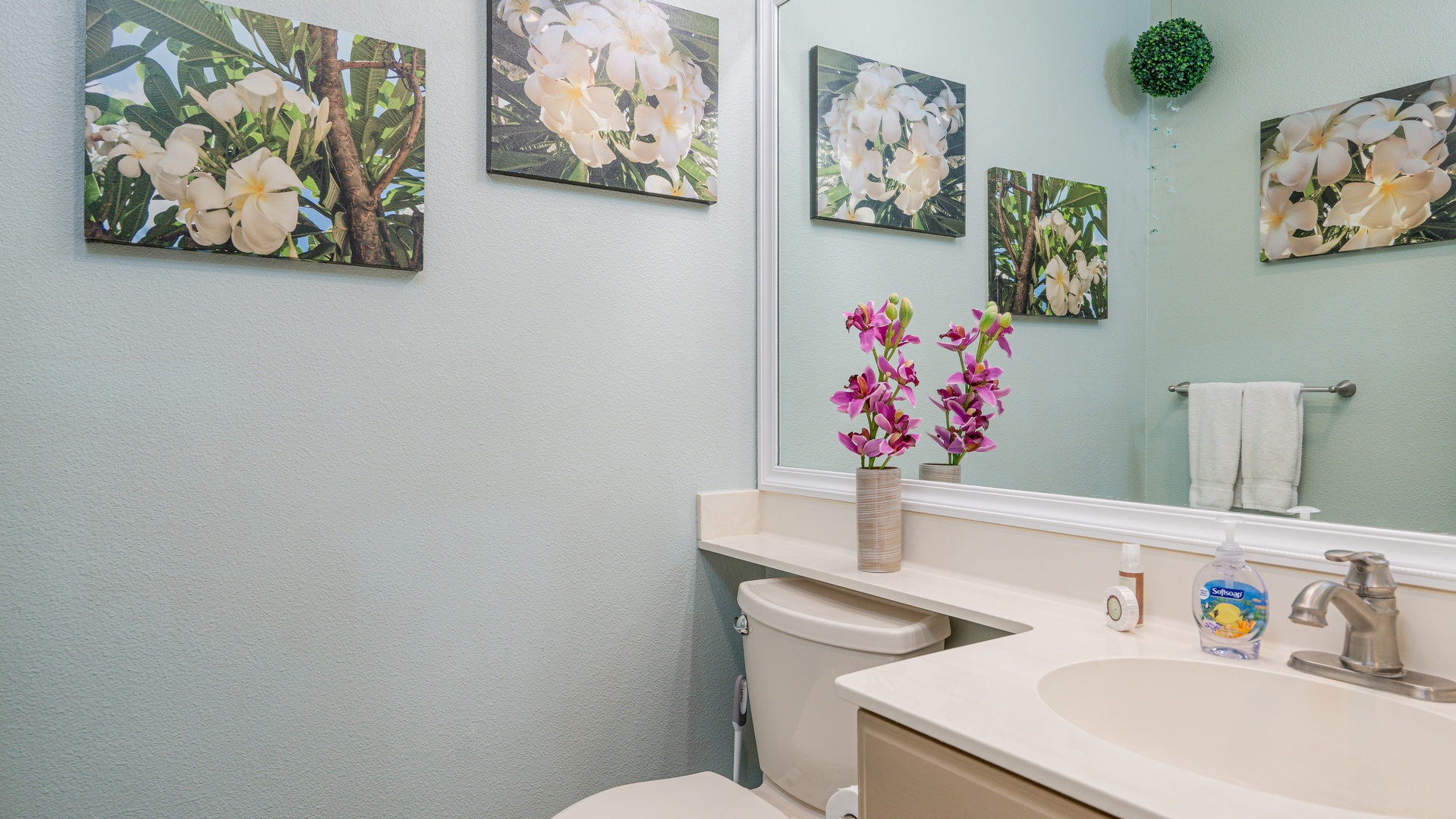 Kapolei Vacation Rentals, Fairways at Ko Olina 8G - Refresh in your thoughtfully decorated bathroom featuring tropical artwork, fresh orchids, and modern amenities for your comfort.