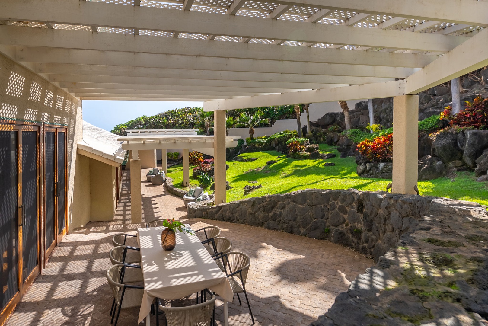 Honolulu Vacation Rentals, Black Point Ocean Villa - Relax on your covered lanai with garden views, where tropical breezes filter through lattice work creating perfect dappled shade for outdoor dining.