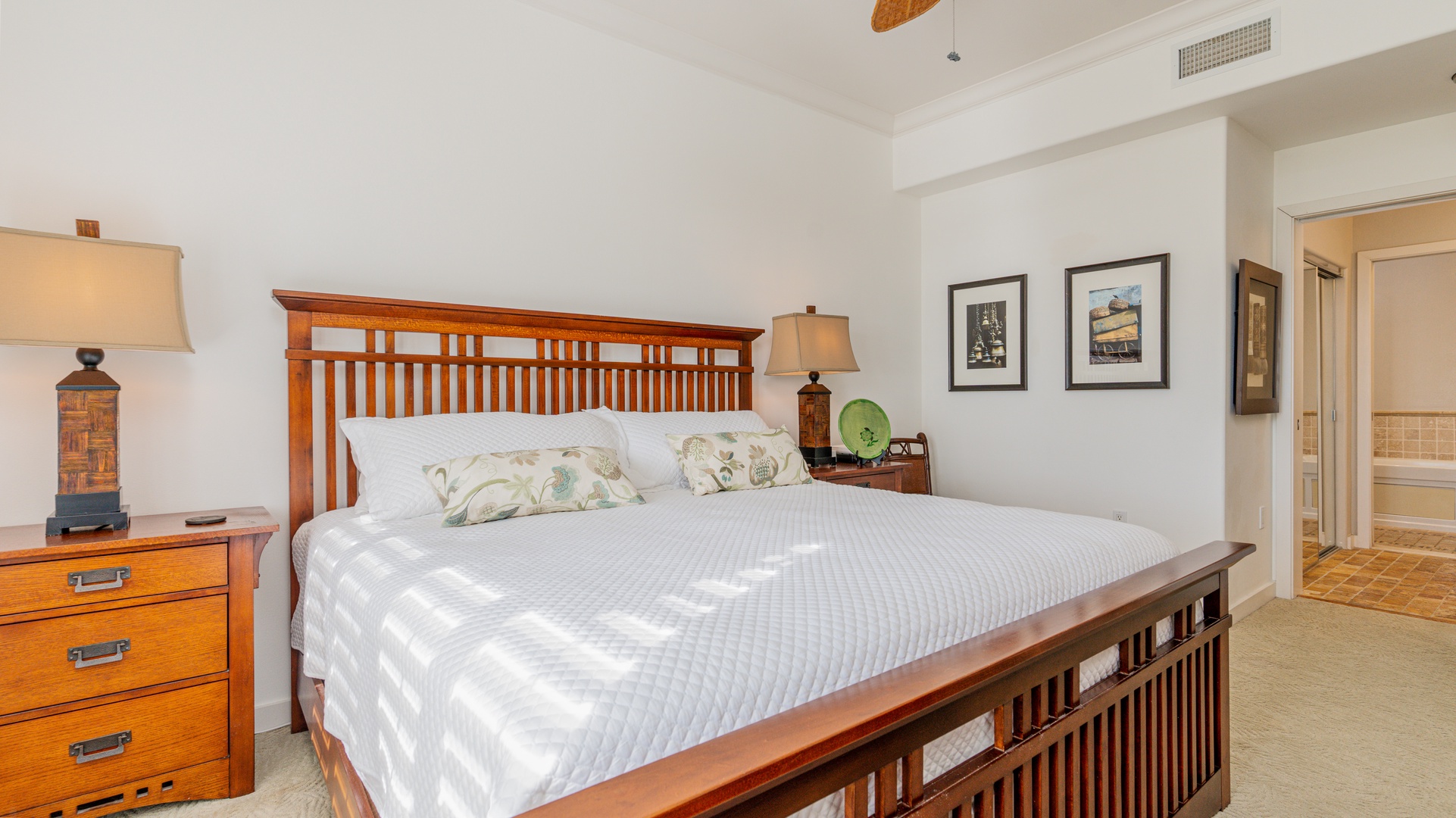 Kapolei Vacation Rentals, Kai Lani 24B - The primary guest bedroom with a king bed and framed art.